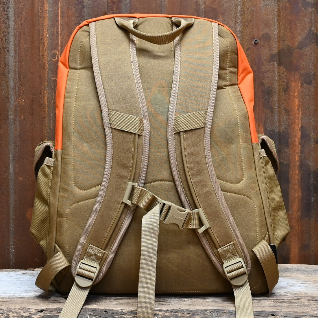 View of Filson Surveyor 36L Backpack in Dark Tan/Flame, featuring dry-waxed Cordura® nylon, padded laptop compartment, and multiple storage pockets