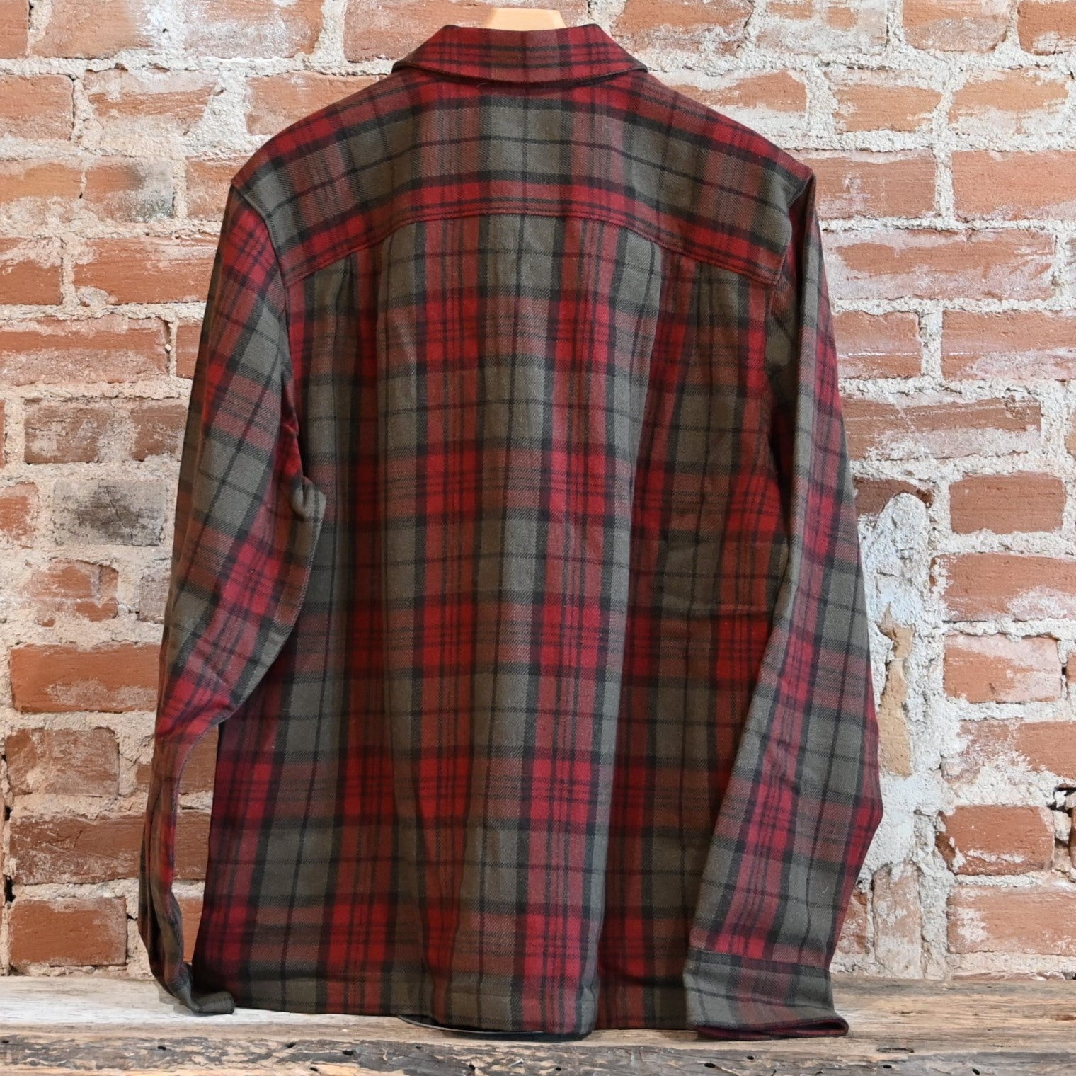 View of Filson Buckner Wool Camp Shirt in Olive Red Multi Plaid featuring unstructured camp collar and button-flap chest pockets