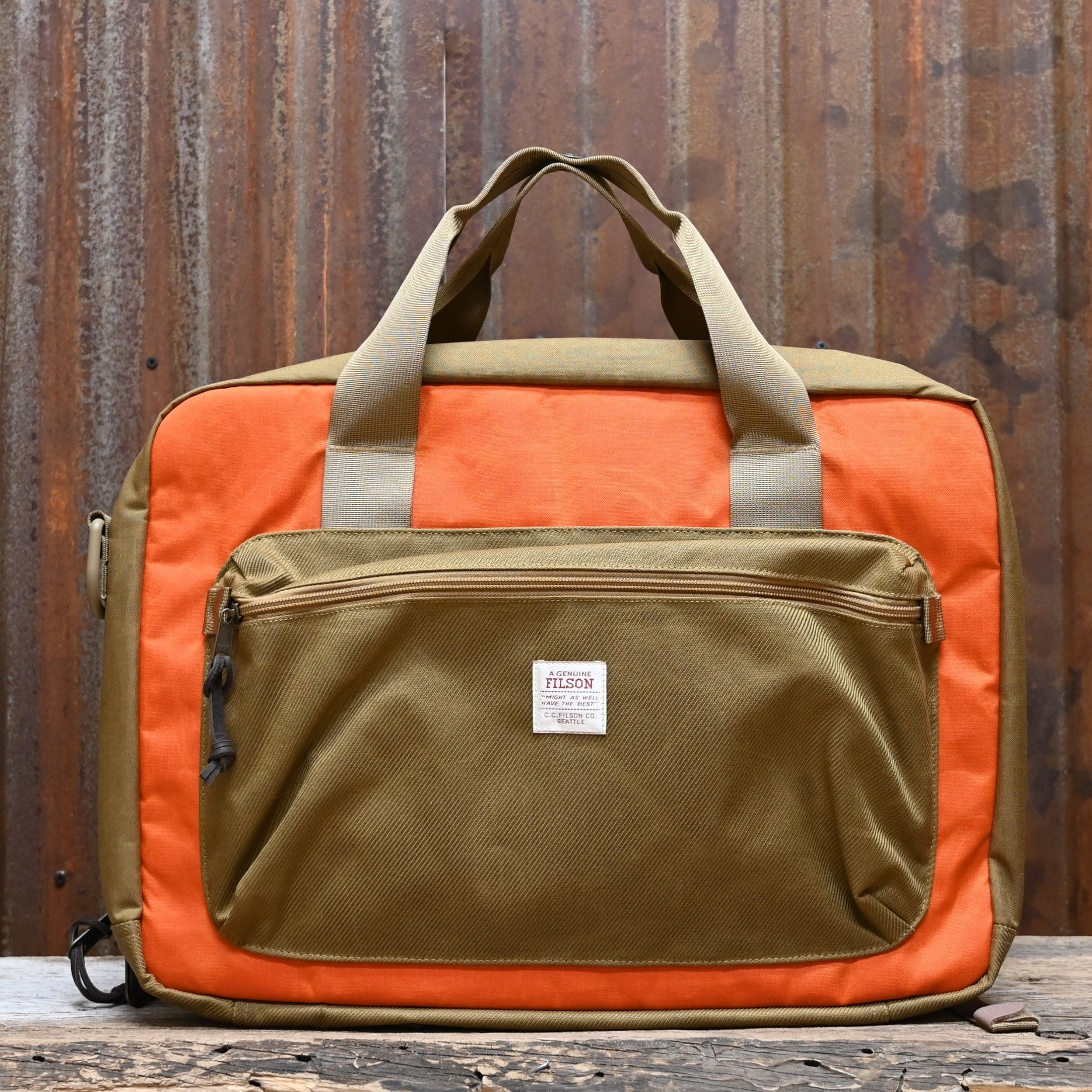 View of Filson Surveyor Pullman Pack in Dark Tan/Flame, showcasing durable Cordura® nylon construction and versatile carry options