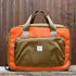 View of Filson Surveyor Pullman Pack in Dark Tan/Flame, showcasing durable Cordura® nylon construction and versatile carry options