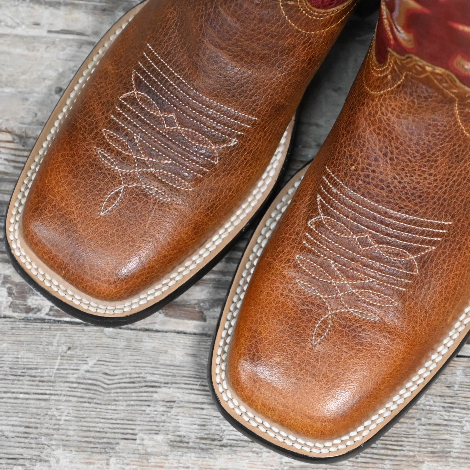 View of Hondo 13" cowboy boot with red volcano top, rust oil tan vamp, and wide square toe