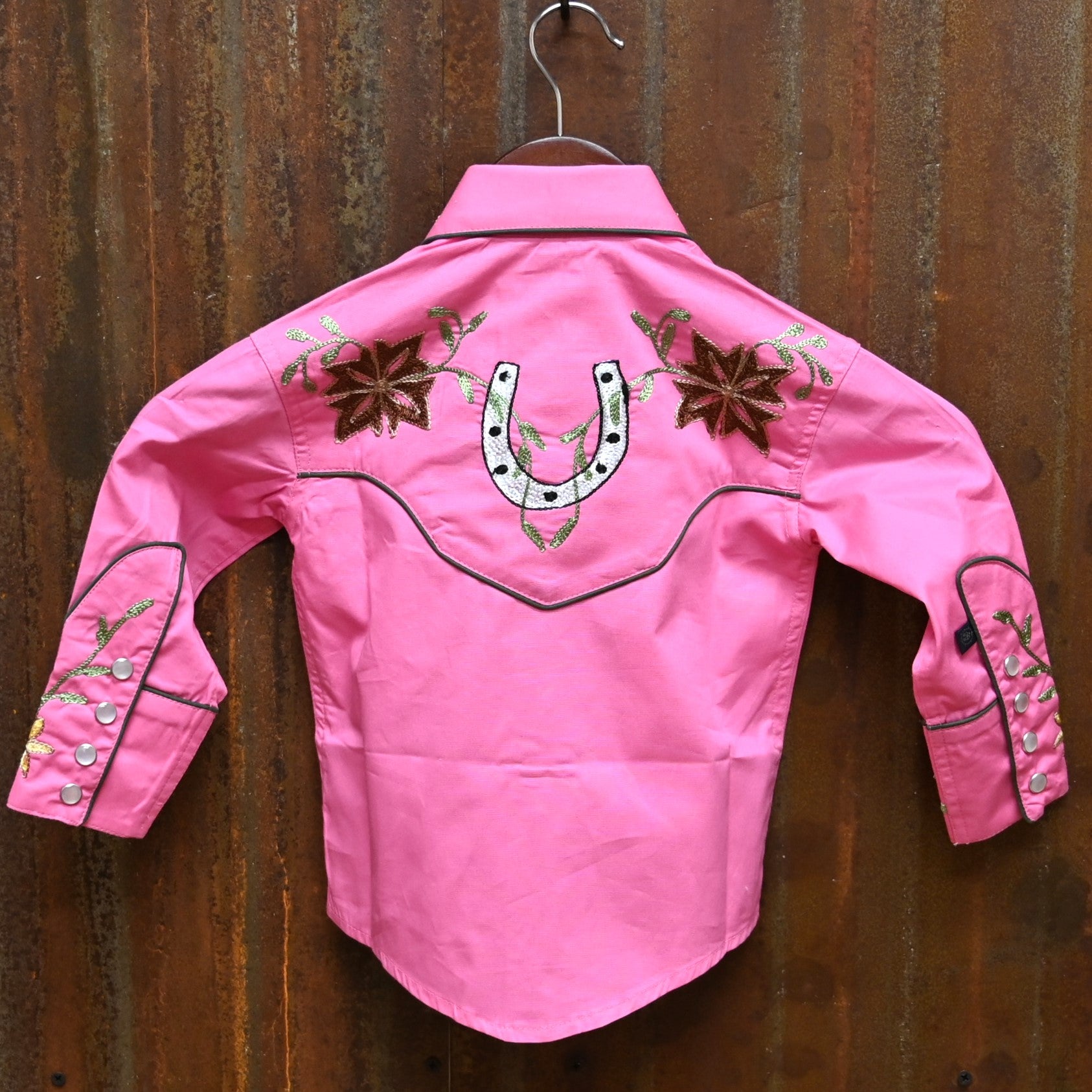 View of Pink Rockmount kids western shirt with embroidered flowers and horseshoes