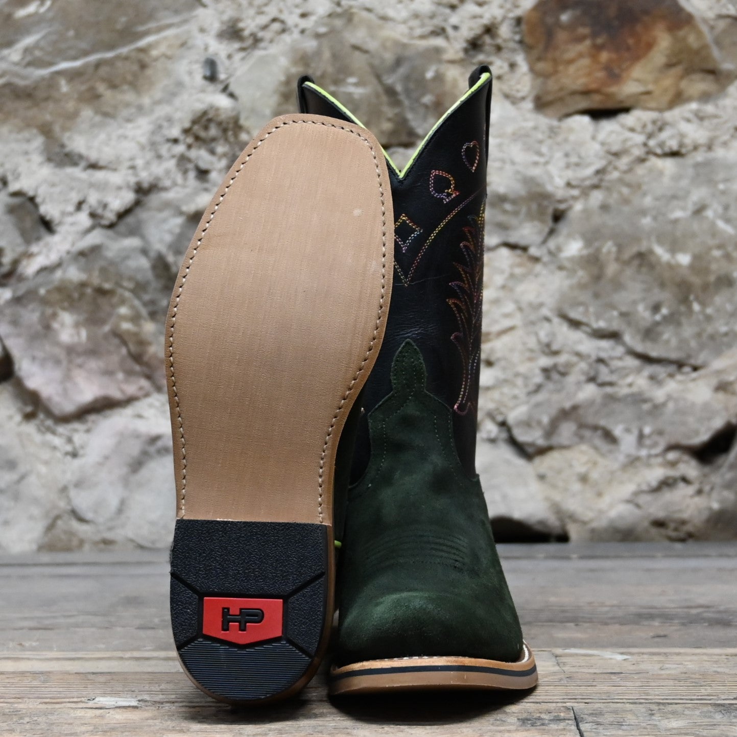 View of Horse Power 11" High Noon boot with emerald suede vamp, tan and black bison top, cutter toe, rainbow stitching, and pull straps