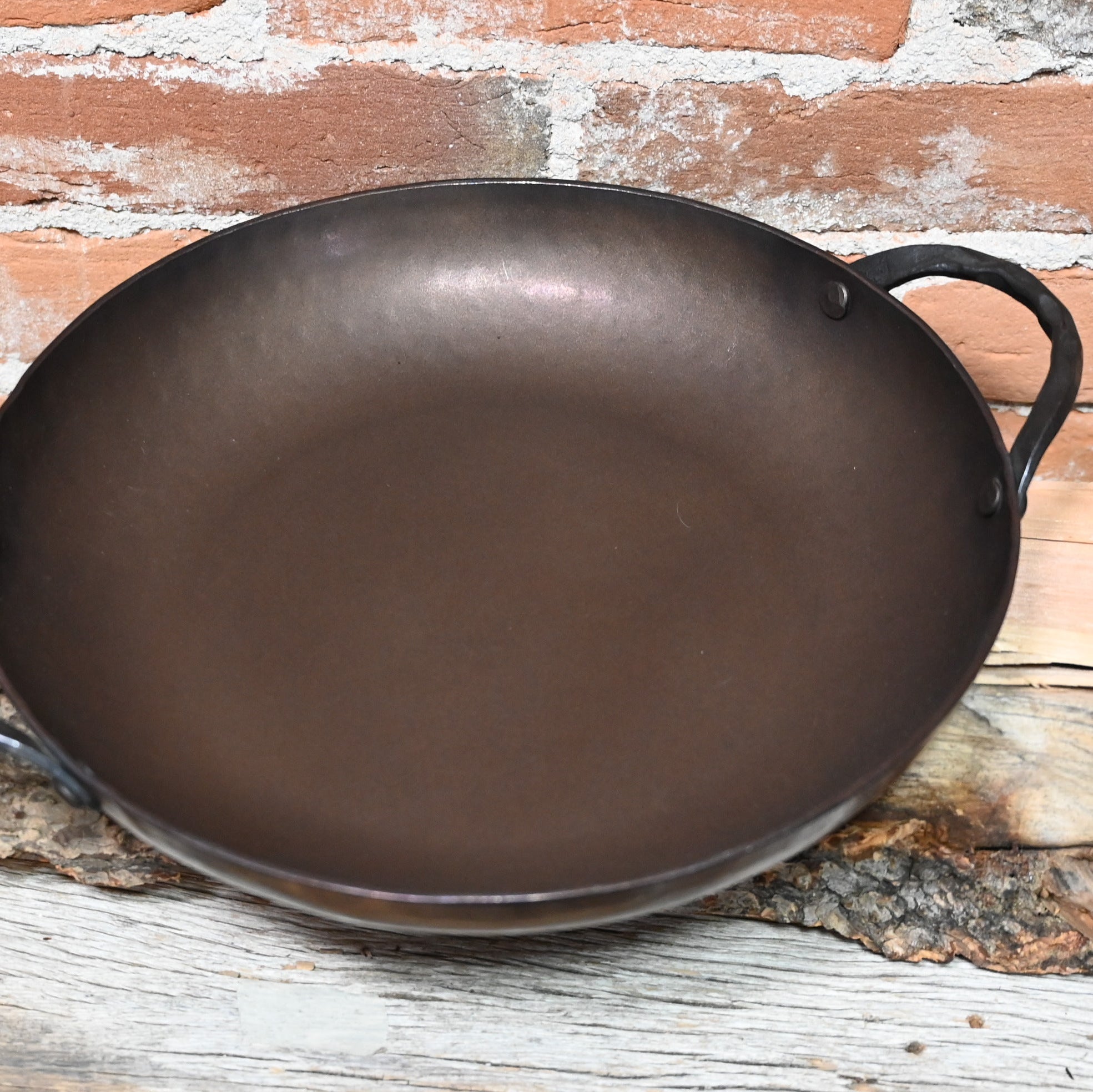View of Smithey 12" Carbon Steel Round Roaster – Hand-forged pan with hammered handles and pre-seasoned interior