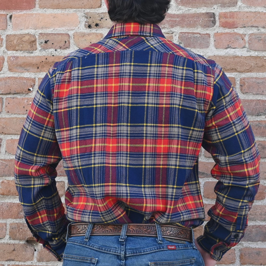 View of Filson Vintage Flannel Work Shirt in assorted colors, showcasing durable cotton twill fabric and pleated back design