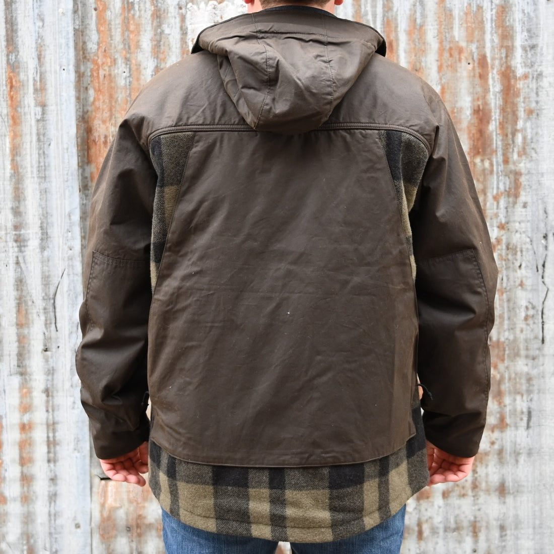 View of Filson Mackinaw Wool Hunting Jacket in Otter Green/Black Plaid featuring oil-finish Cover Cloth overlays and fleece-lined pockets