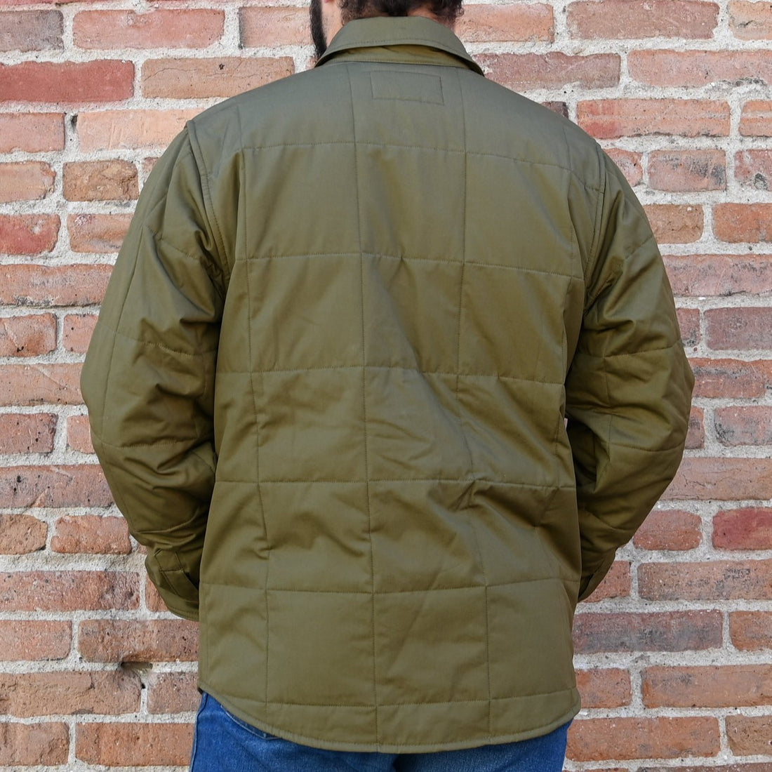 View of Filson Cover Cloth Quilted Jac-Shirt in Olive Drab and Cinder featuring snap-front closure, snap-flap chest pockets, and flannel-lined hand pockets