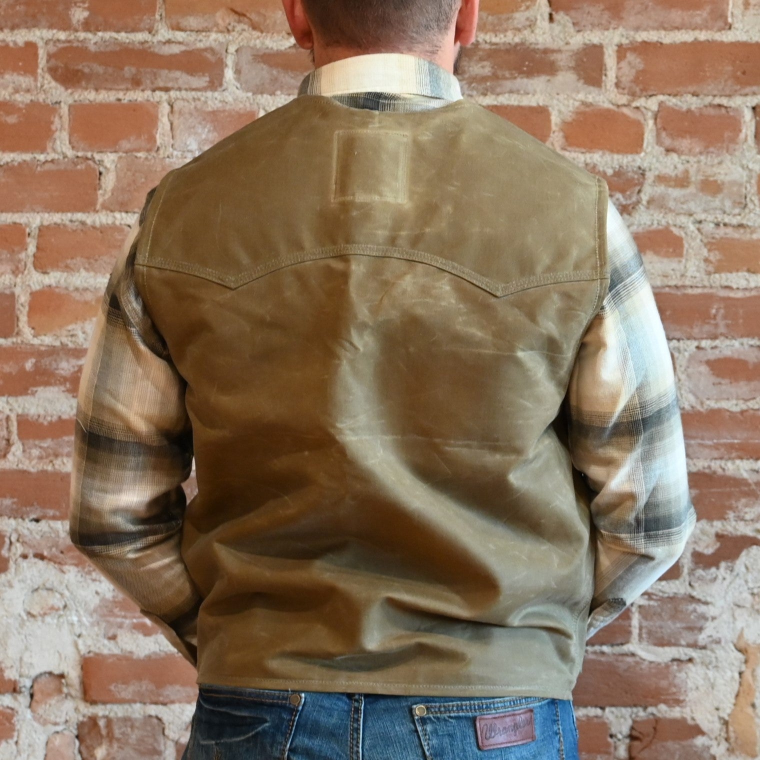 View of Schaefer waxed canvas Mesquite Vest in Saddle and Oak with four front pockets and Western yokes