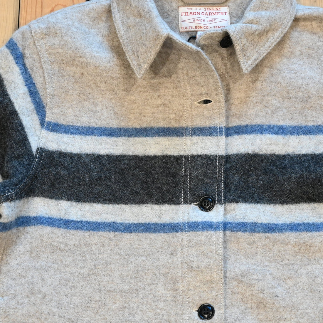 Filson Ladies Wool Overshirt in gray with black blanket stripes, chest pockets, and button front