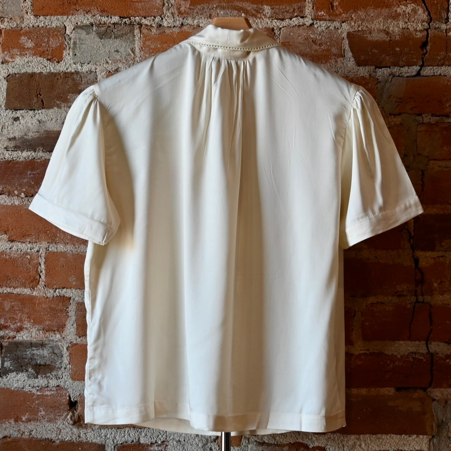 Silky white lace blouse by Sendero with floral embroidery and delicate cotton lace at collar and center front