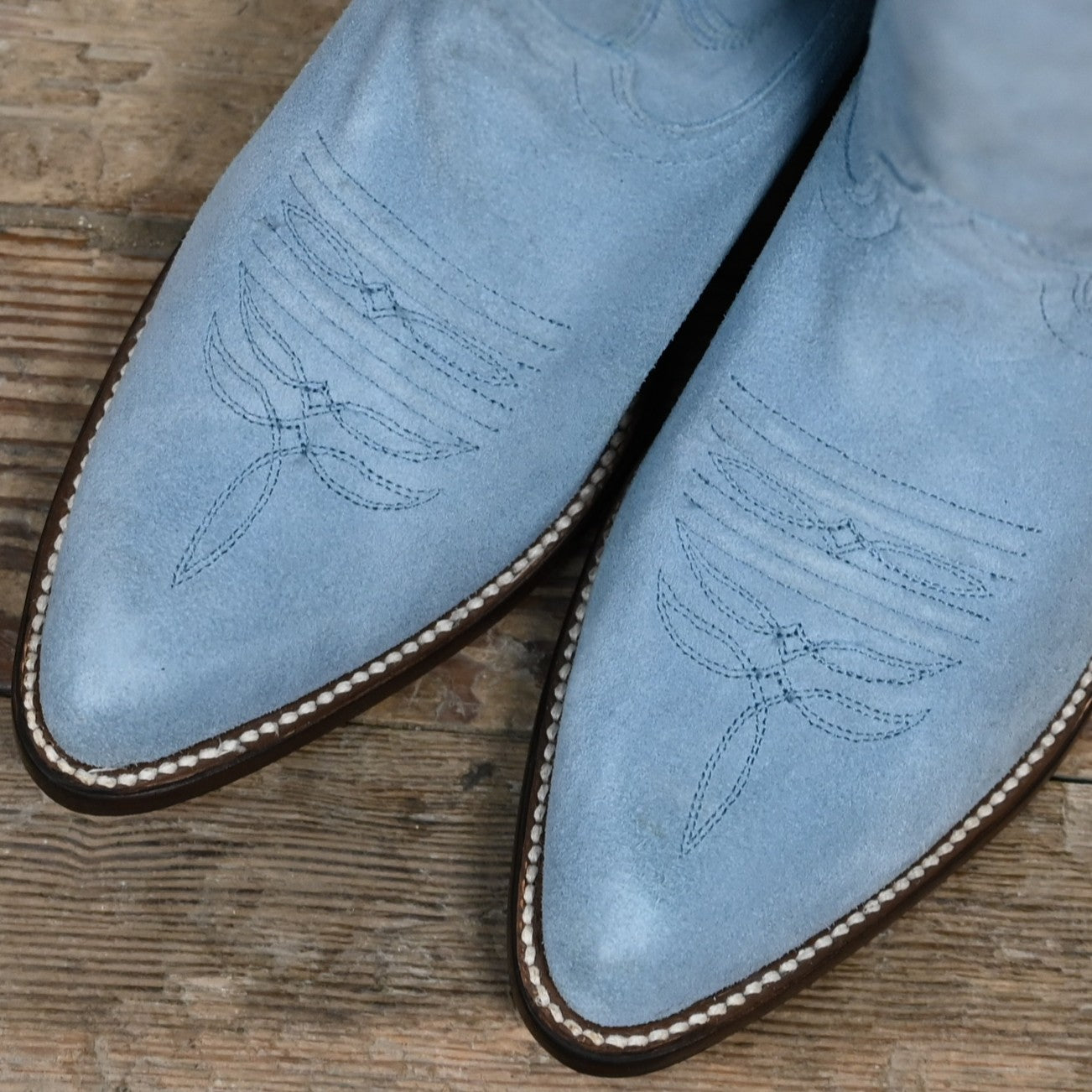 View of Macie Bean 15" baby blue suede boot with almond toe and cowgirl heel