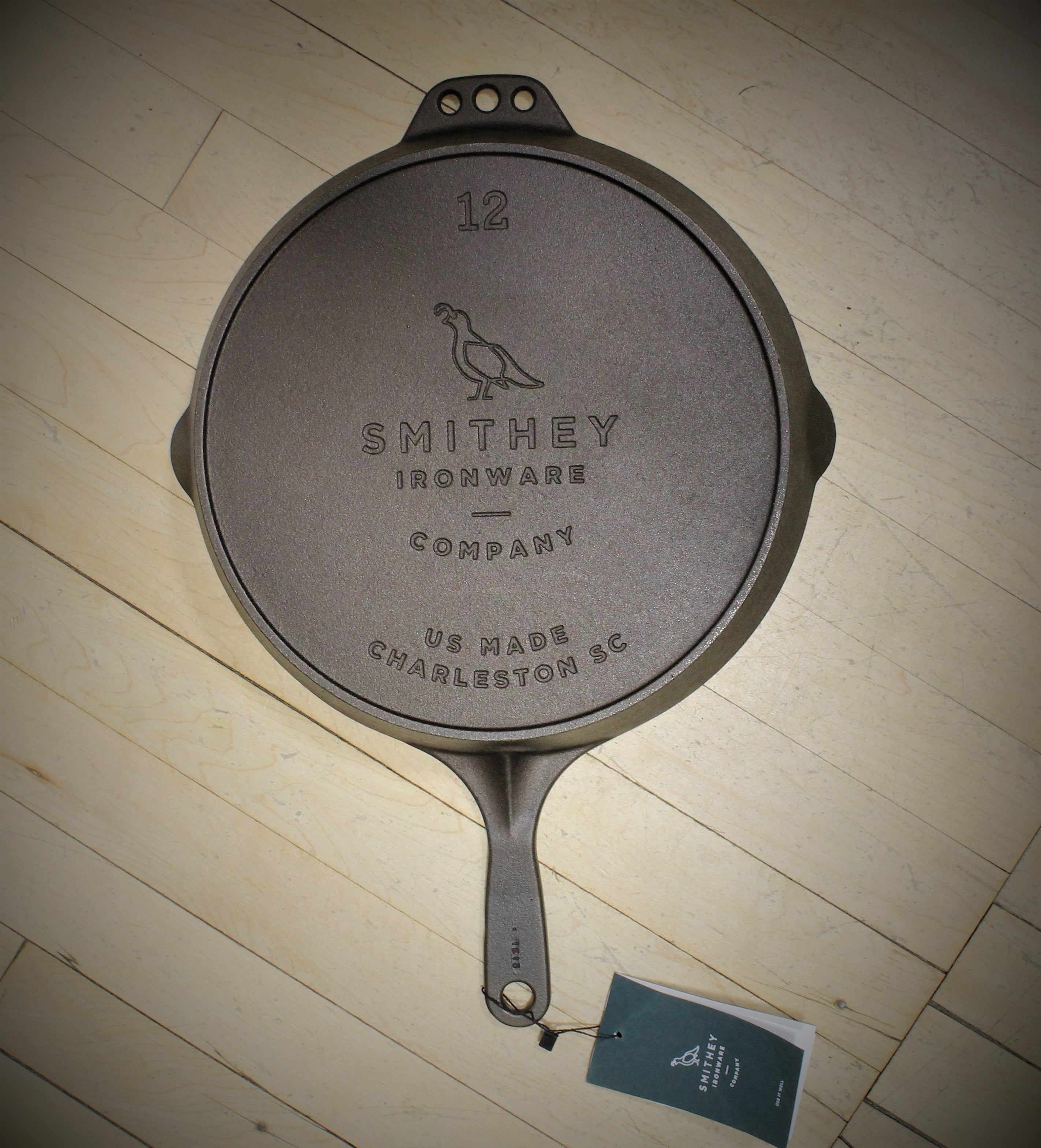 View of Smithey Ironware No. 12 Cast Iron Skillet with polished surface and ergonomic handle