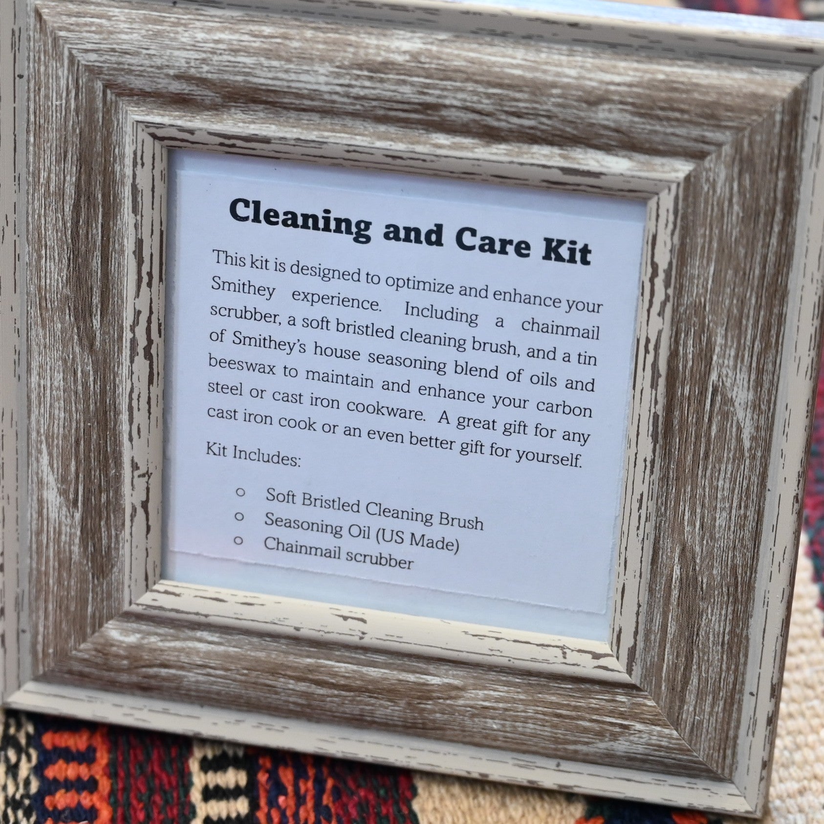 View of Smithey Ironware Cleaning & Care Kit: chainmail scrubber, seasoning oil, and cleaning brush