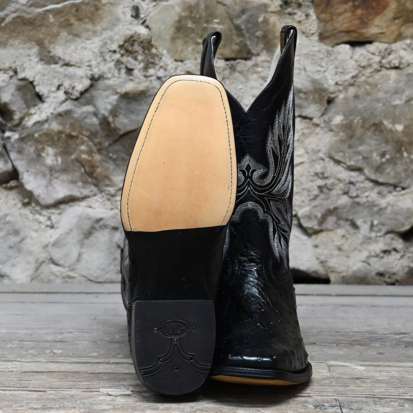 View of Hondo full quill black ostrich boot with black volcano top, 13" height, and pull straps