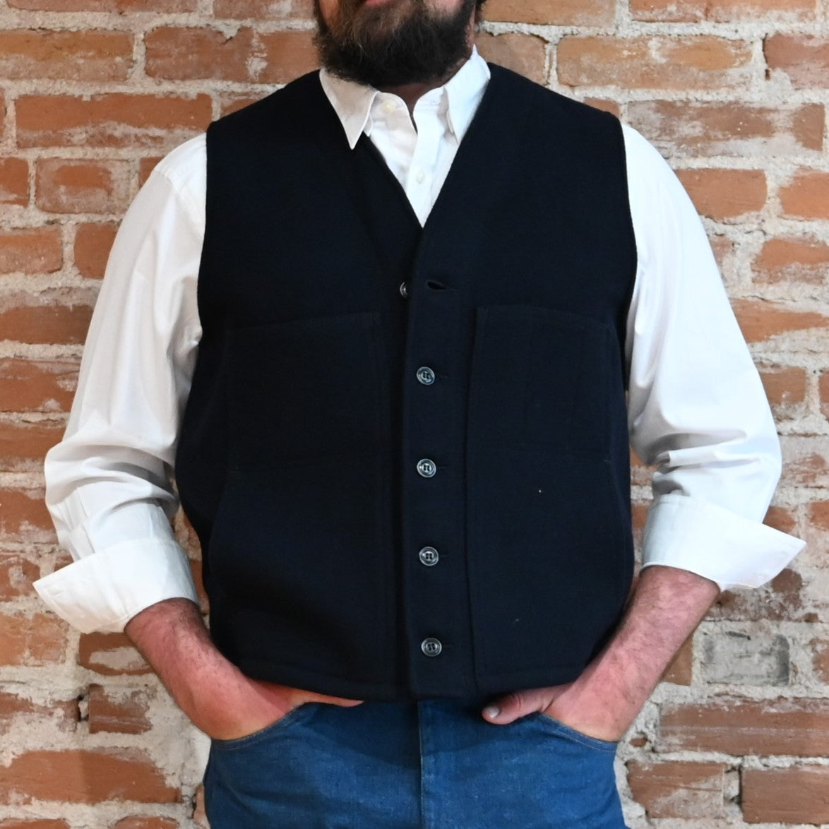 Filson Mackinaw Wool Vest in Dark Navy featuring V-neckline, button-front closure, and multiple pockets.