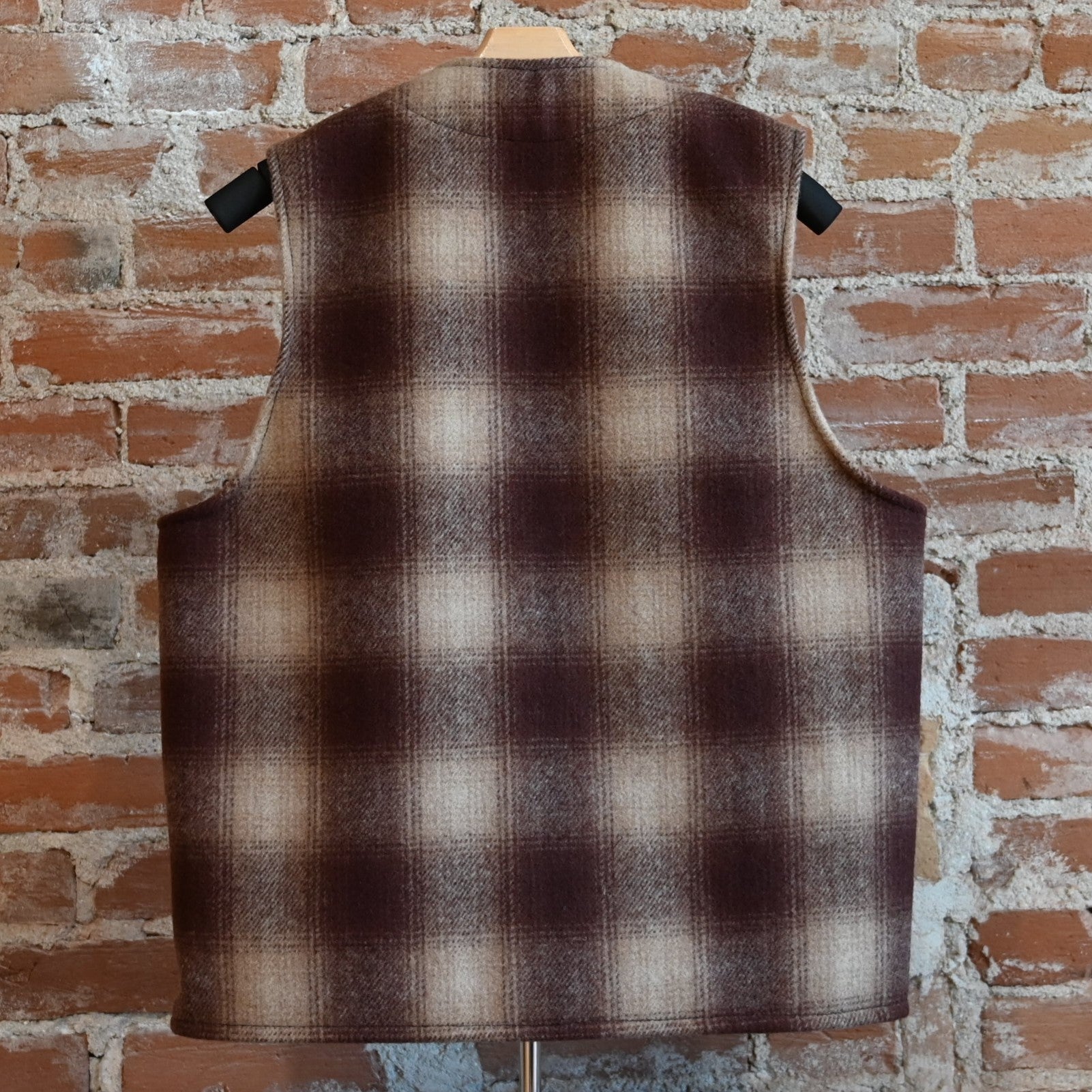 View of Filson Mackinaw Wool Vest in Brown/Tan Ombre featuring V-neckline, button-front closure, and multiple pockets