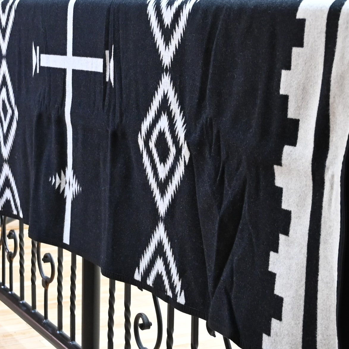 View of Pendleton Los Ojos queen blanket with reversible black and white geometric jacquard pattern