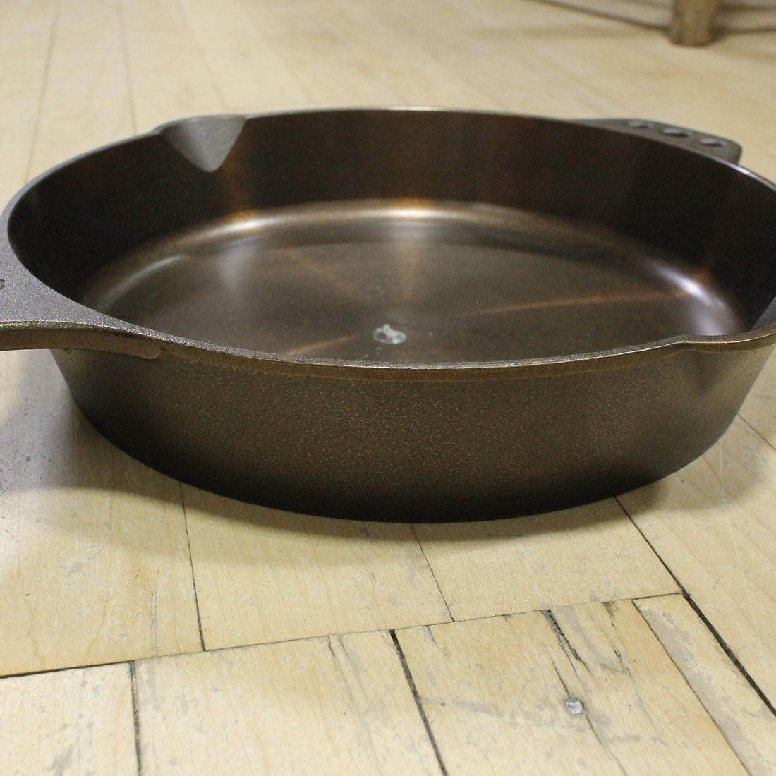 View of Smithey Ironware No. 10 Cast Iron Skillet with polished interior and ergonomic handle