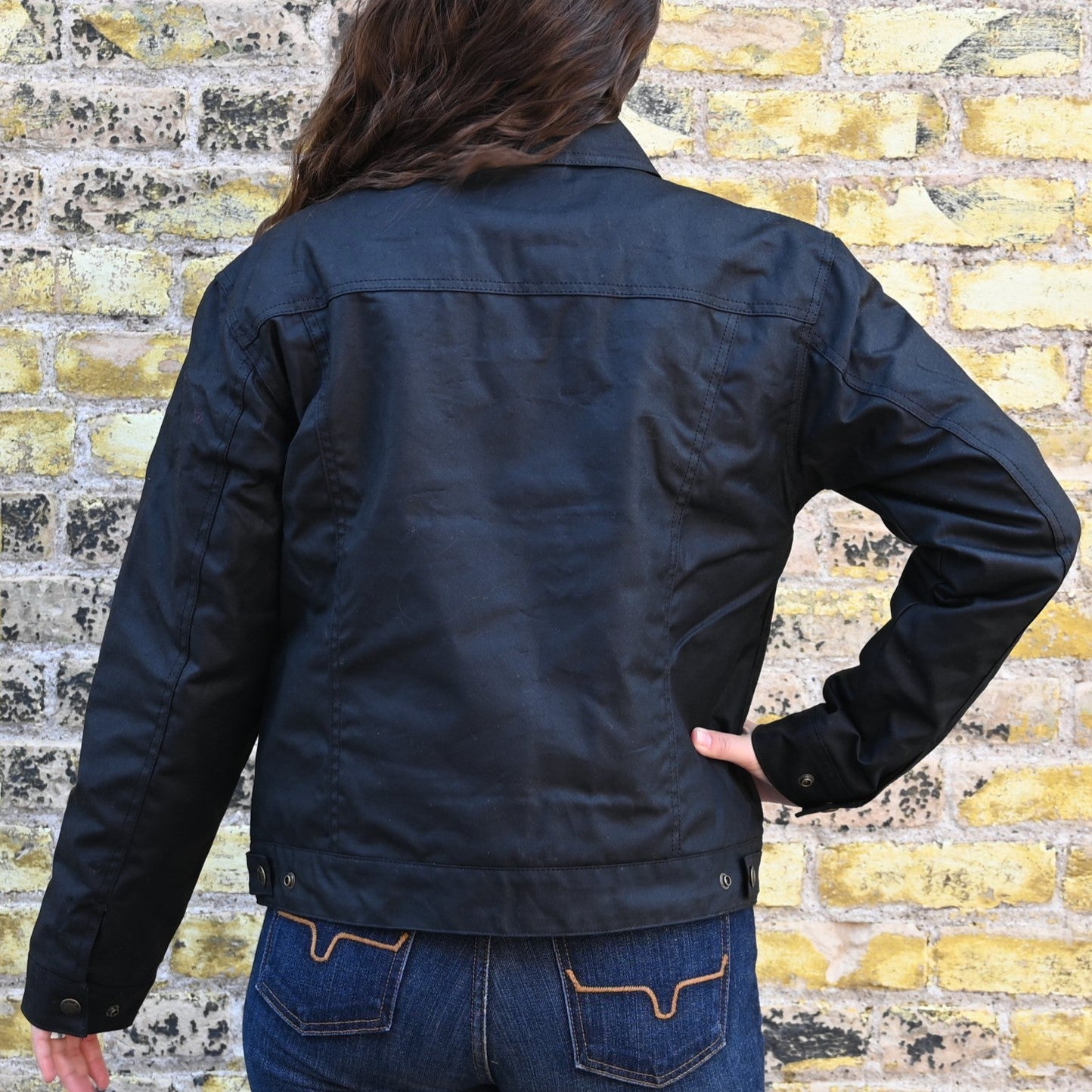 View of Filson Ladies Short Lined Cruiser in Black featuring adjustable cuffs and hem, with a relaxed fit and waxed cotton construction