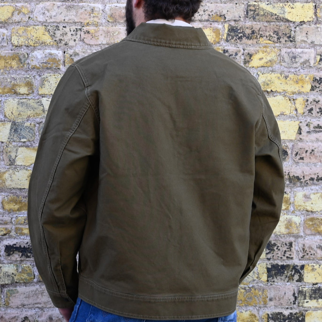 View of Filson Jungle Cloth Work Jacket featuring snap-secure front, adjustable cuffs, and multiple pockets