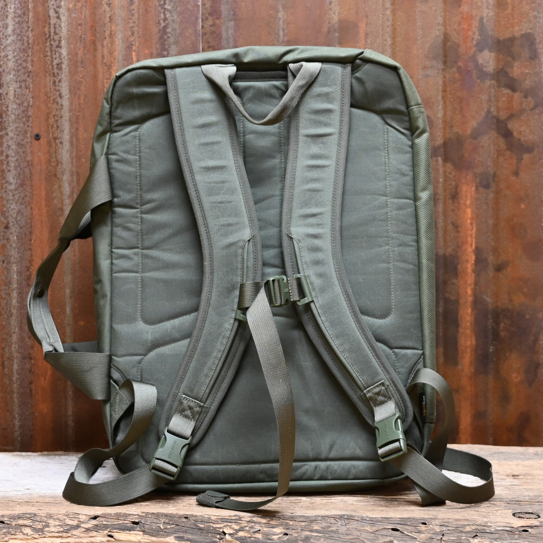 View of Filson Surveyor Pullman Pack in Service Green, showcasing its durable construction and spacious design