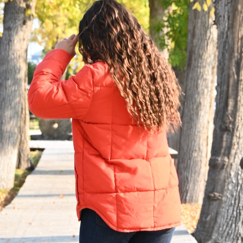 View of Filson Ladies Waxed Down Barn Coat in Campfire featuring antique-finish brass snaps and microfleece-lined hand pockets