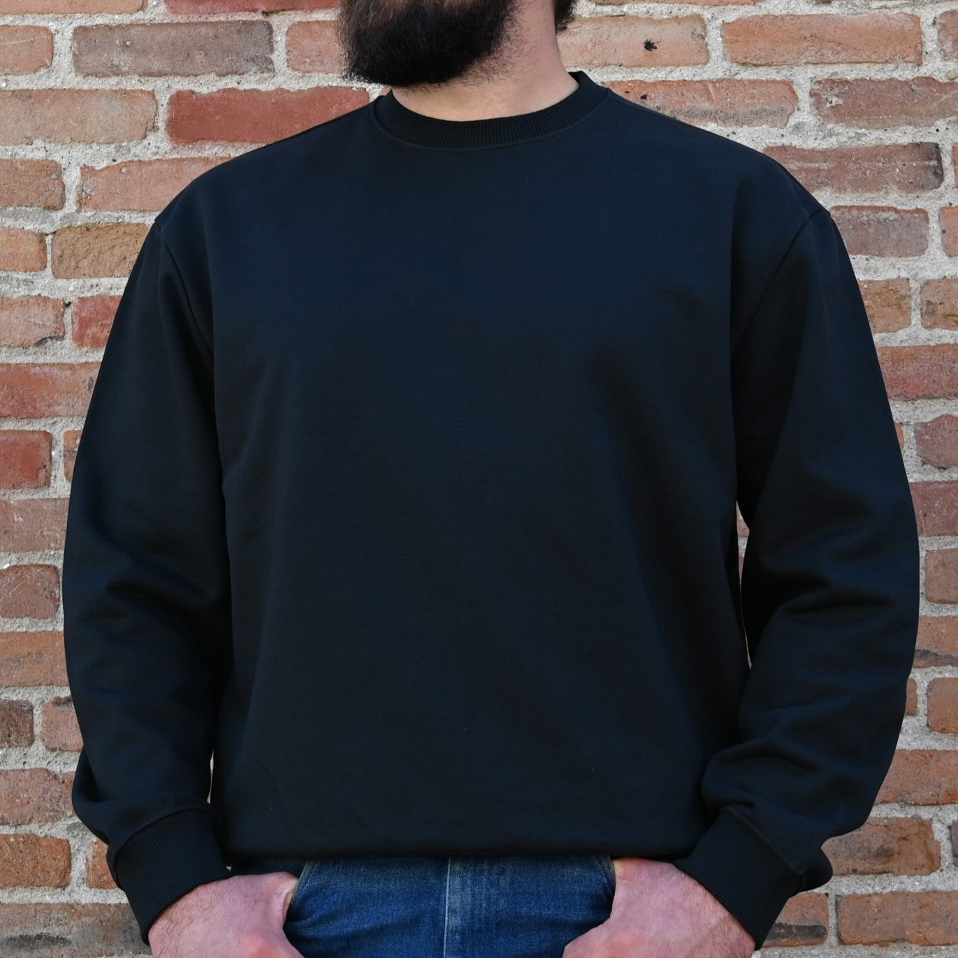 View of Filson Prospector Crewneck Sweatshirt in Black, showcasing the lofted fleece interior and rib-knit hem and cuffs