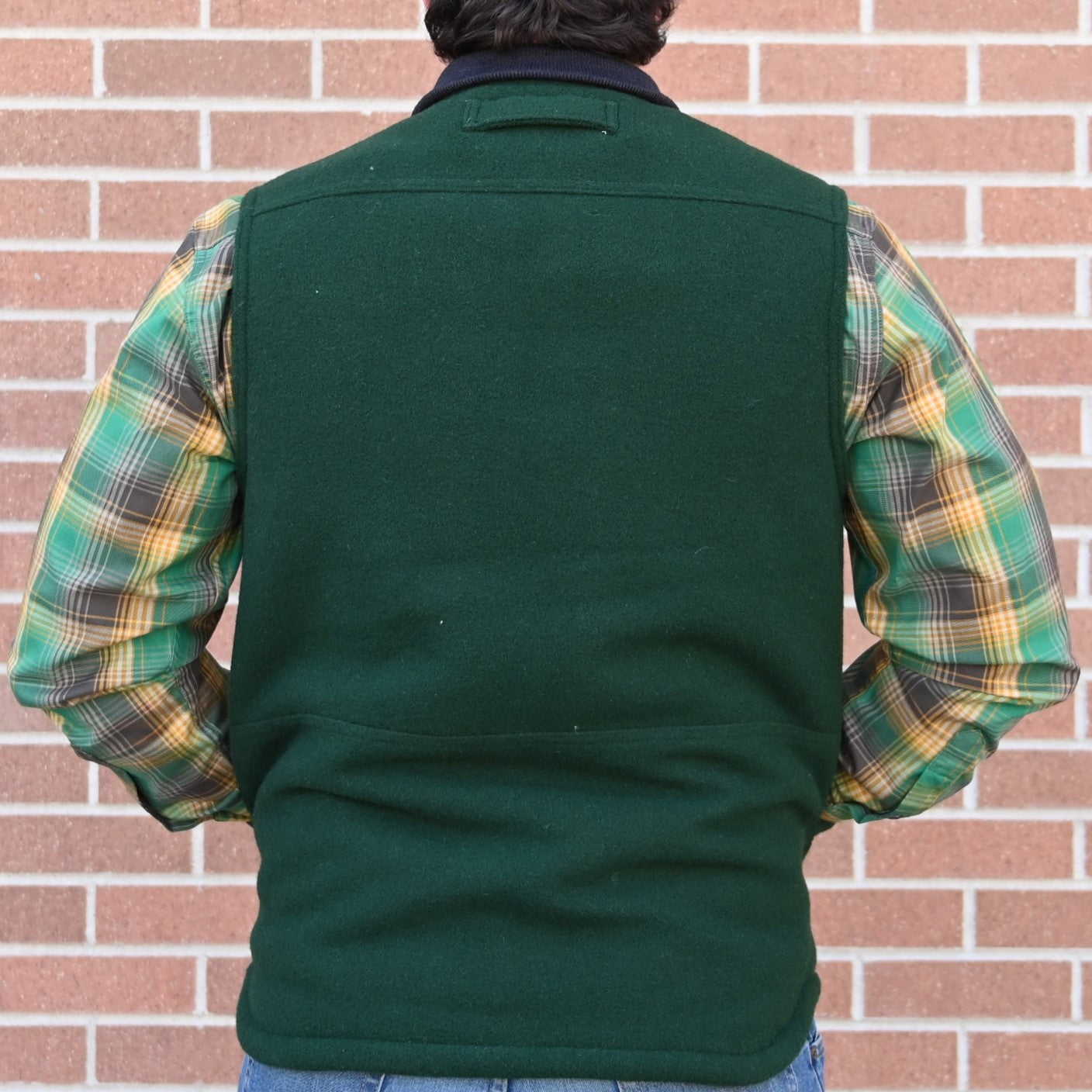 View of Filson Lined Mackinaw Wool Work Vest in Dark Spruce and Charcoal featuring zipper-front closure, wool-blend rib-knit collar, and multiple pockets