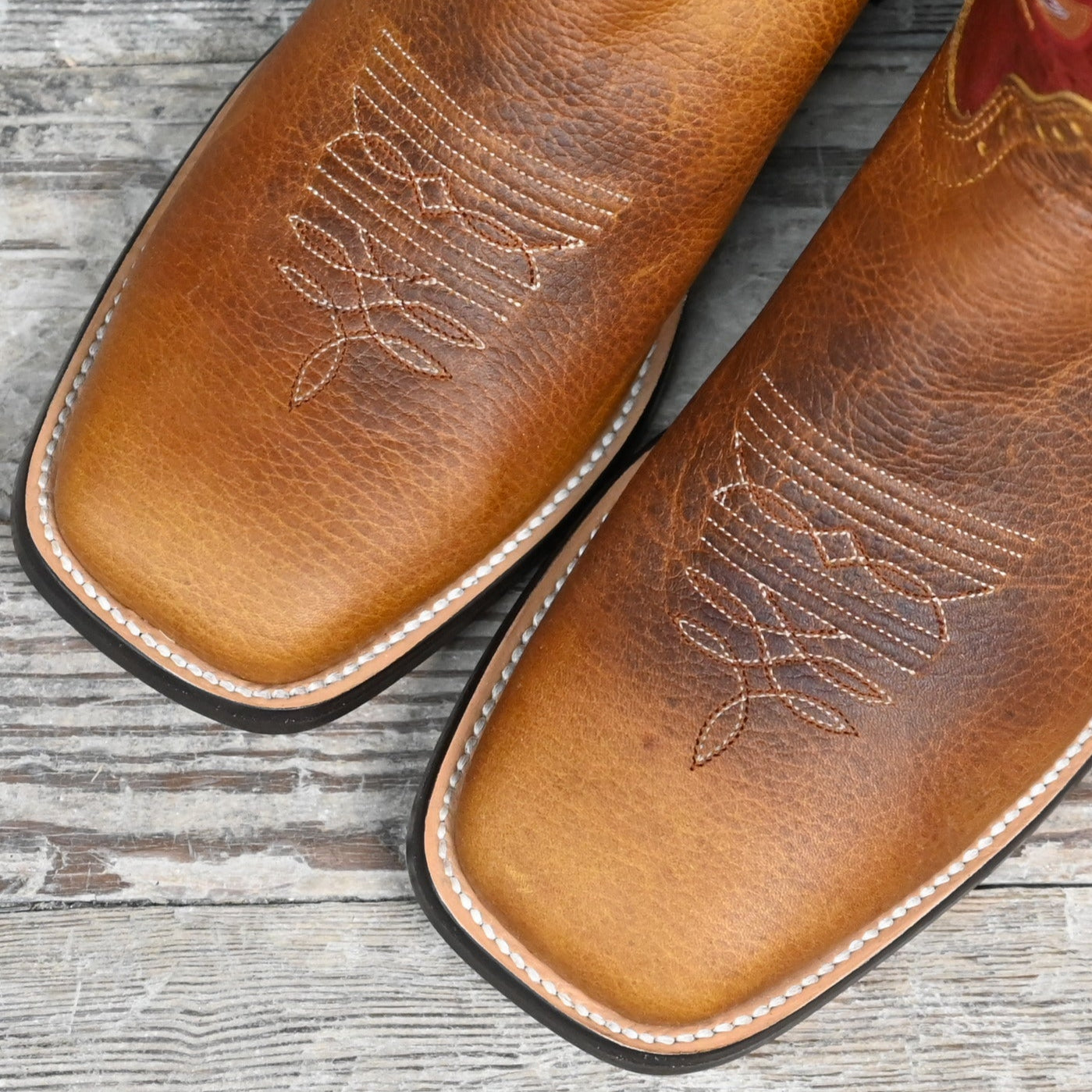 View of Hondo 13" cowboy boot with red volcano top, rust oil tan vamp, wide square toe, and spur ledge