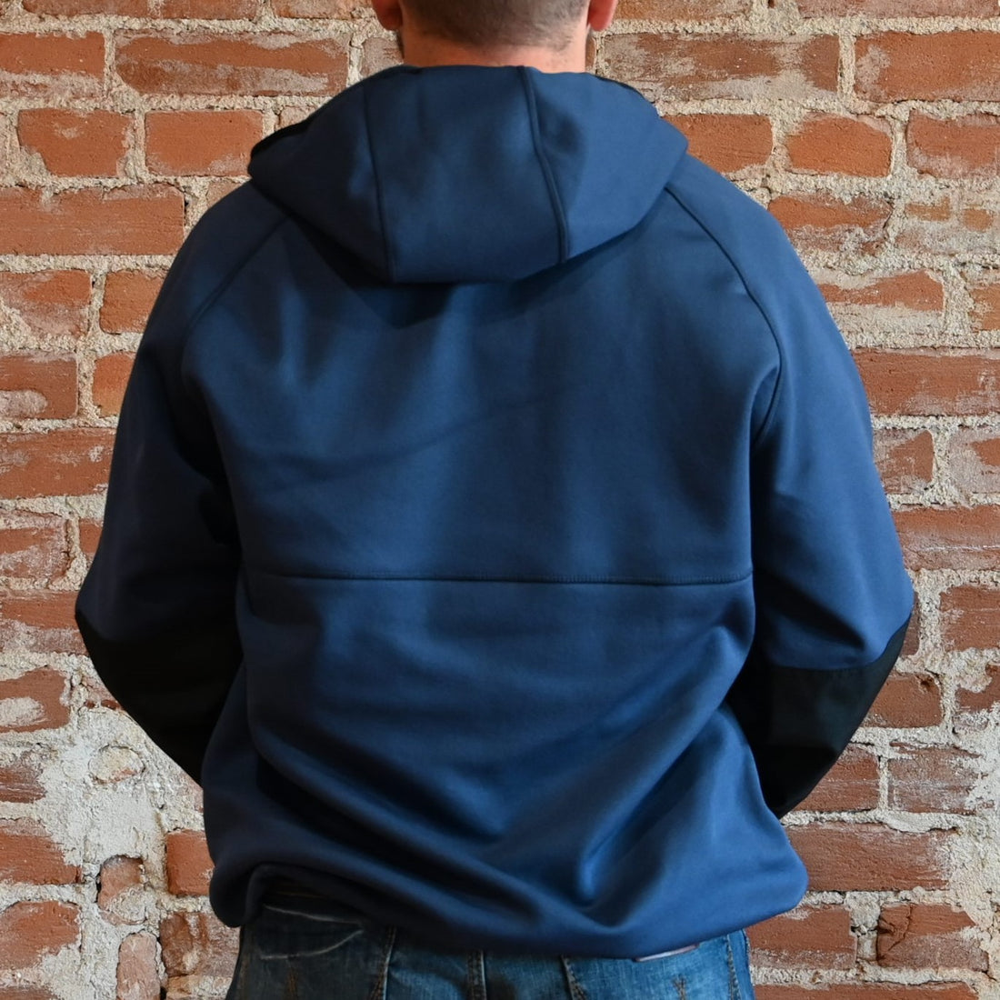 View of Filson Granite Spire Fleece Pullover in Service Blue featuring Cordura® nylon-reinforced forearms and microfleece-lined handwarmer pockets