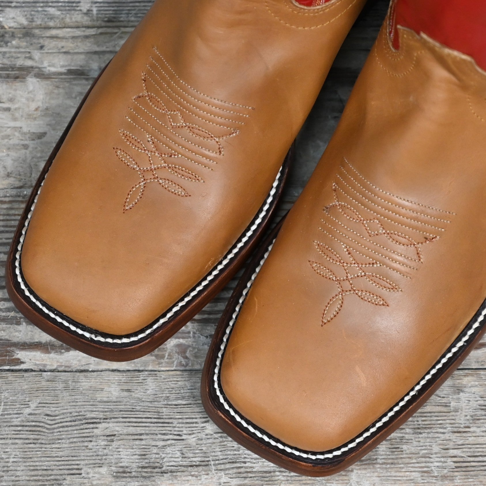 View of Hondo 16" cowboy boot with red top, honey crazy horse vamp, wide square toe, pull holes, and spur ledge