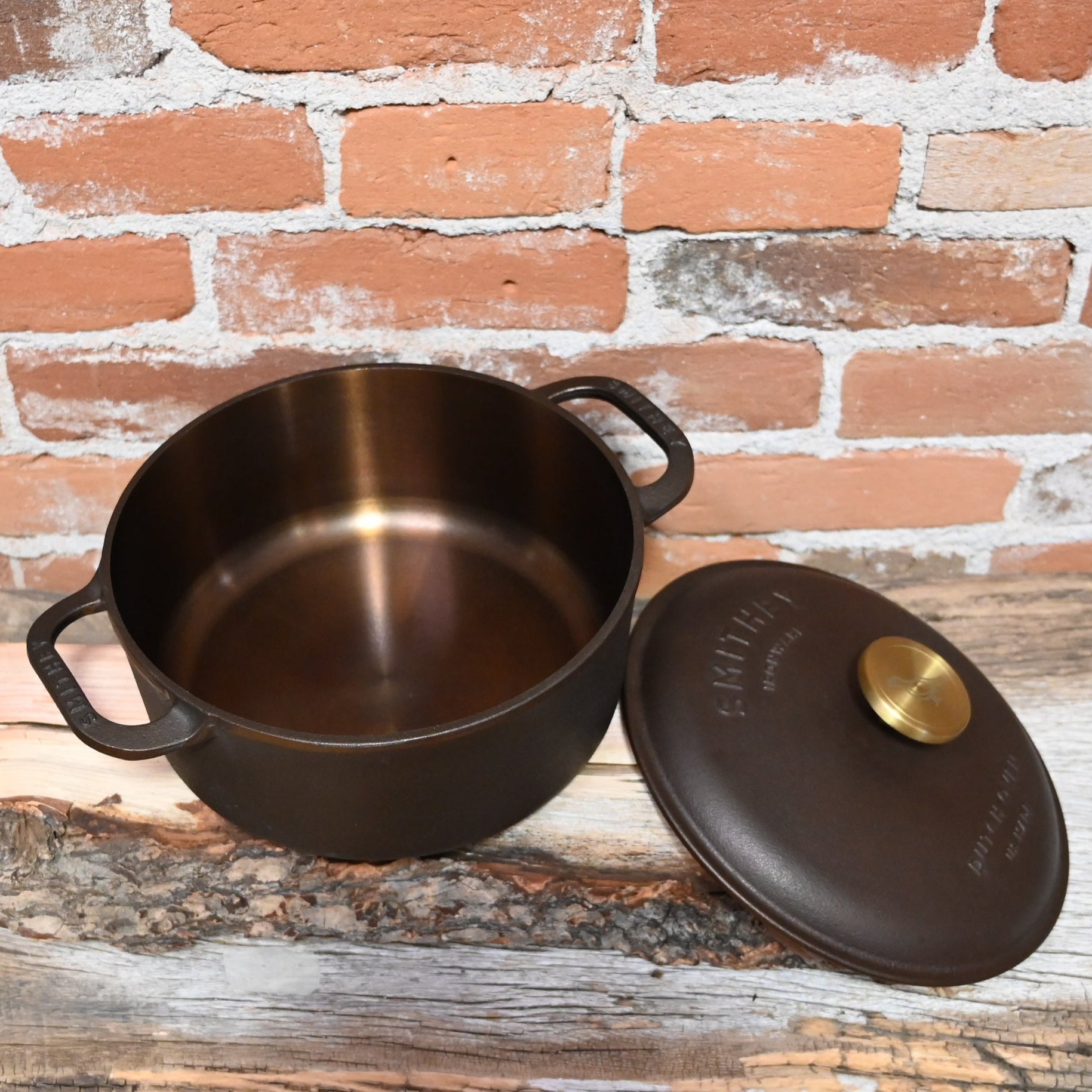 View of Smithey 3.5 Qt Cast Iron Dutch Oven with polished interior and brass knob