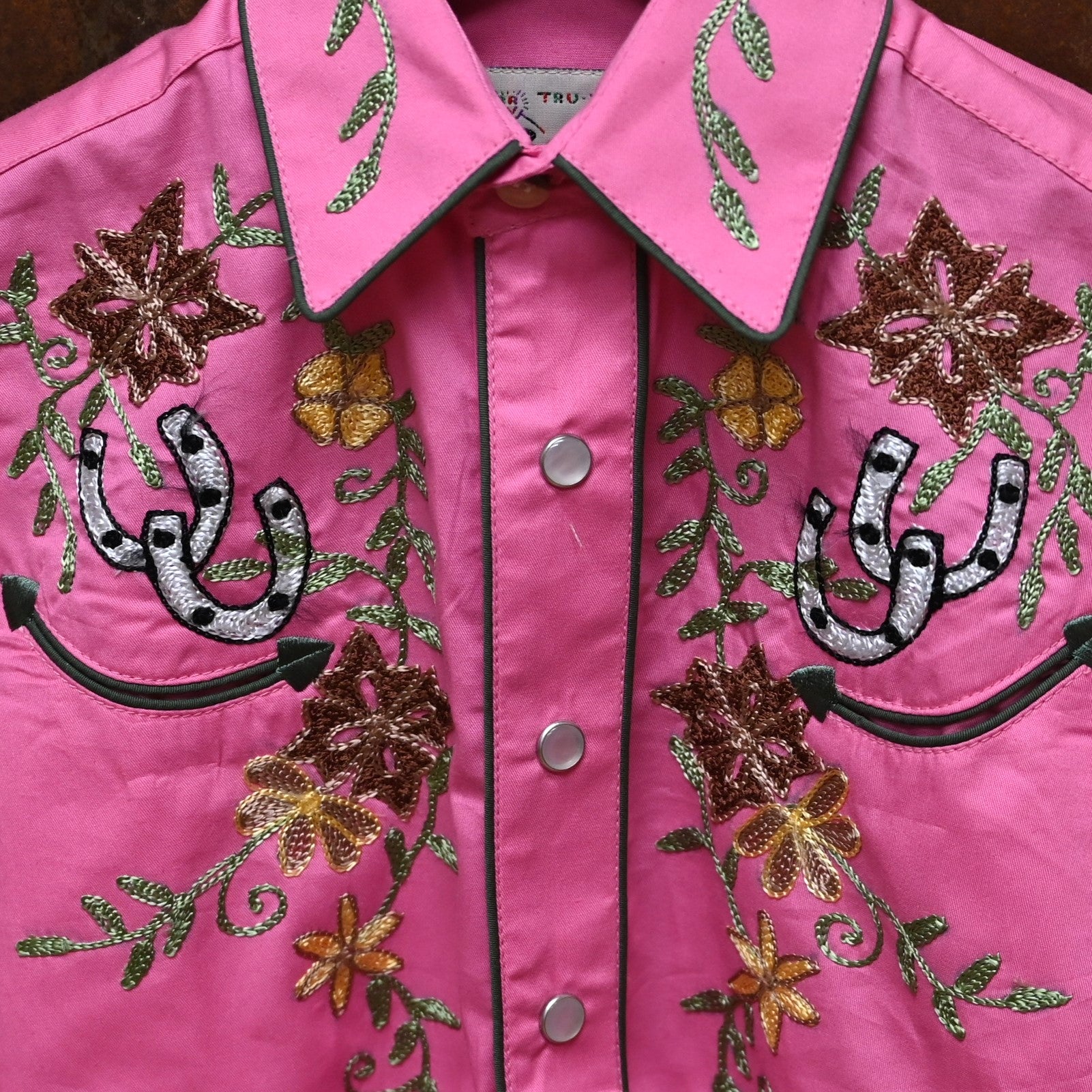 View of Pink Rockmount kids western shirt with embroidered flowers and horseshoes