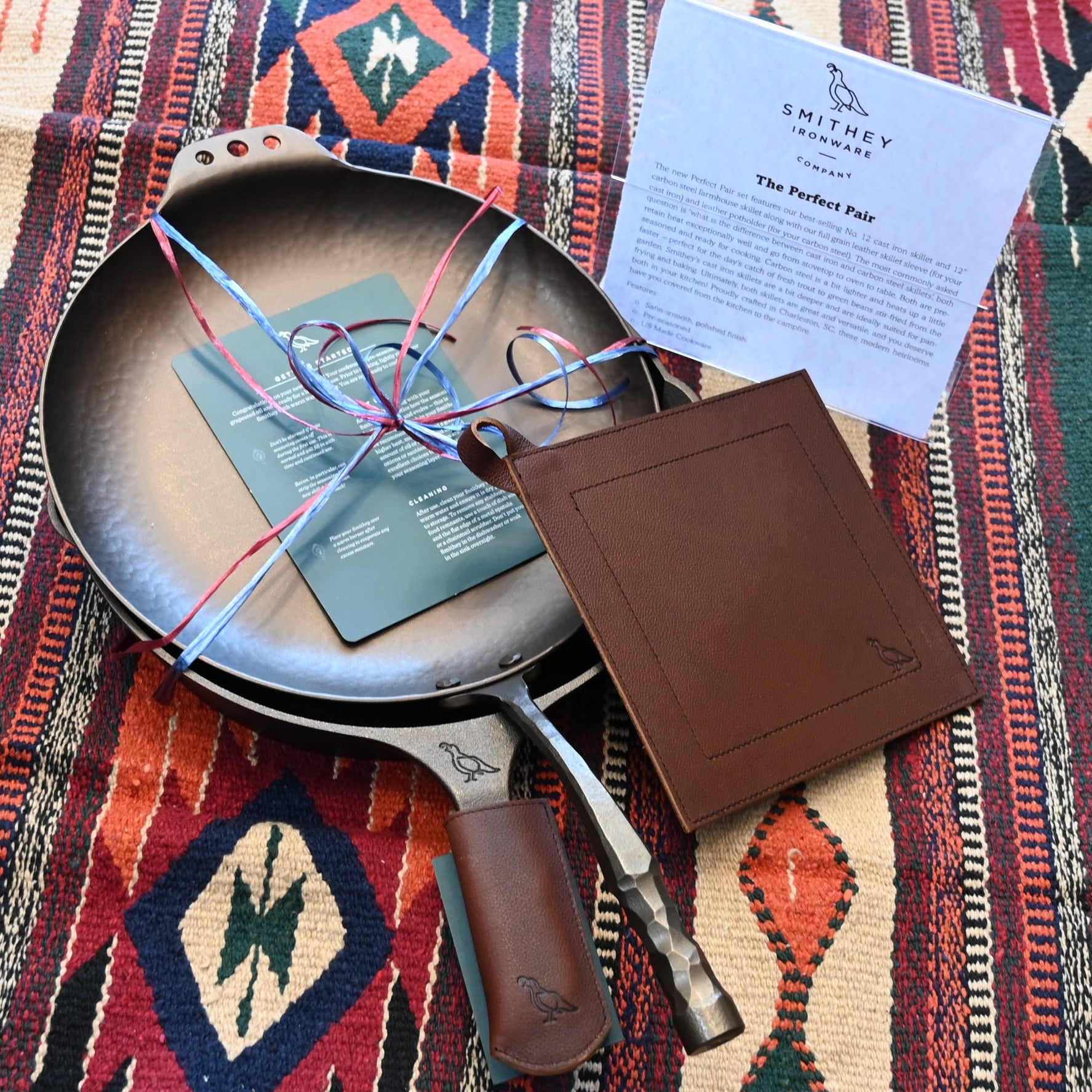 View of Smithey Ironware Perfect Pair Set: No. 12 Cast Iron Skillet and 12" Carbon Steel Farmhouse Skillet with full grain leather sleeve and potholder