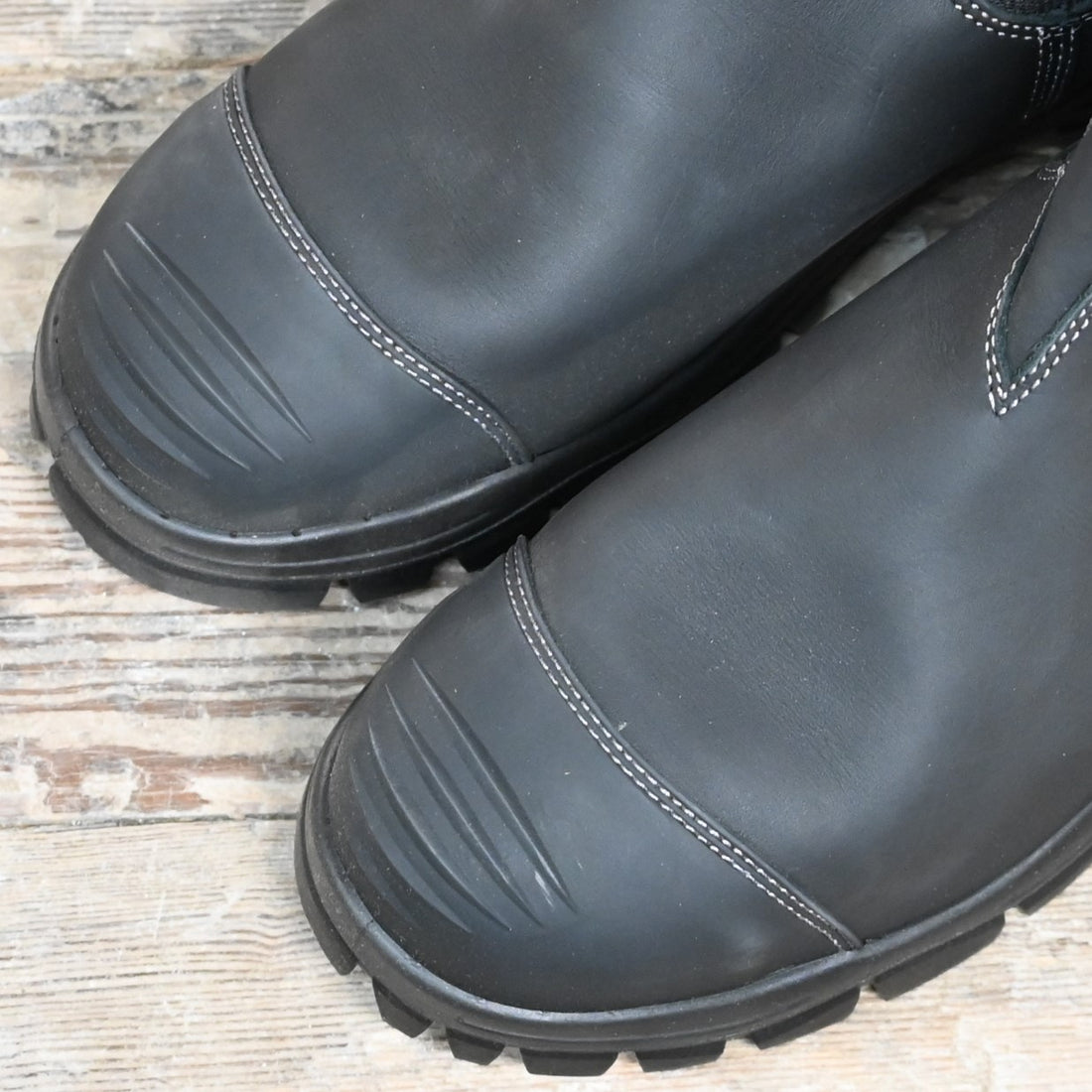 Blundstone Slip On work boot in black leather with steel toe, elastic sides, and safety-rated outsole