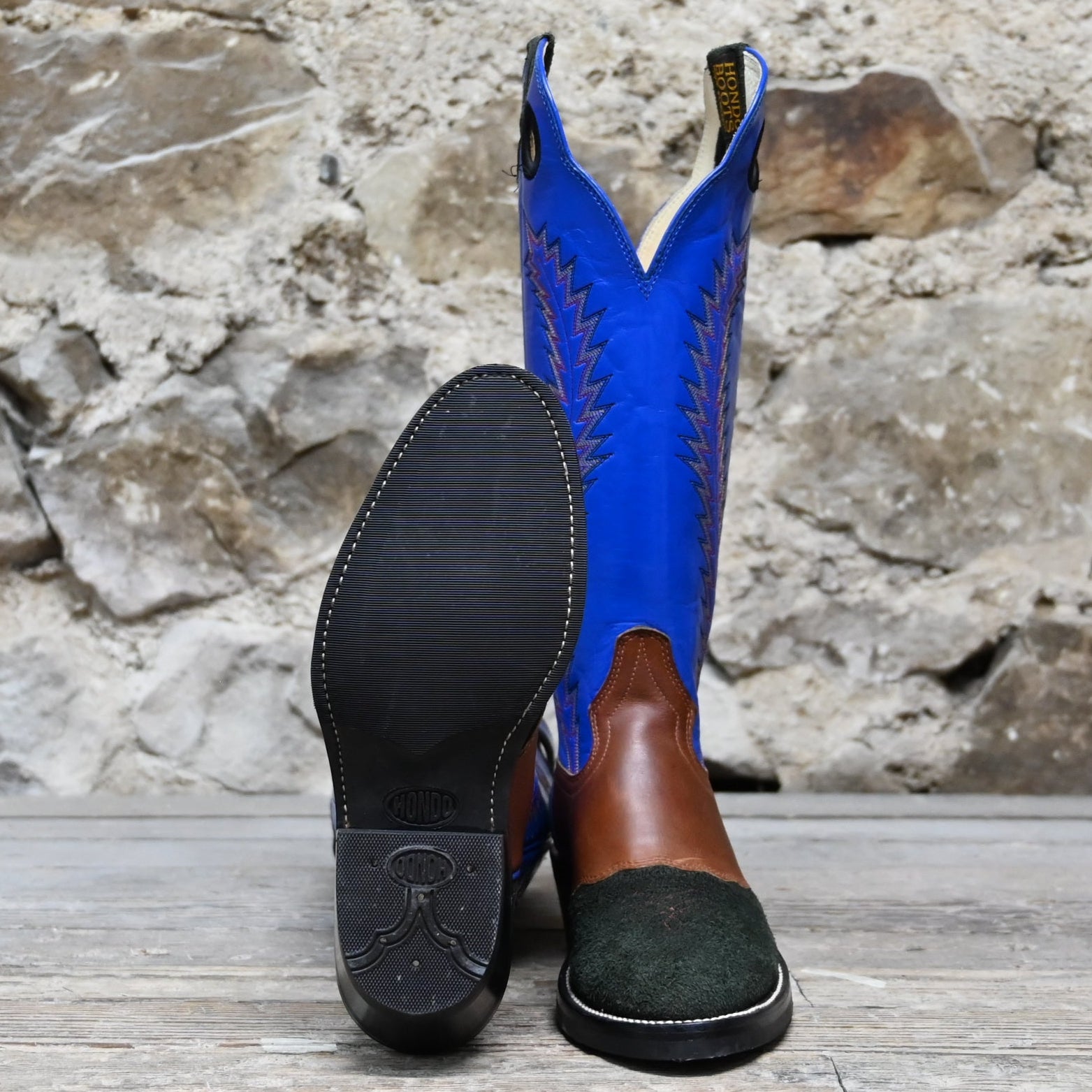 View of Hondo 16" cowboy boot with royal blue top, black roughout vamp, brown overlay, and pull holes