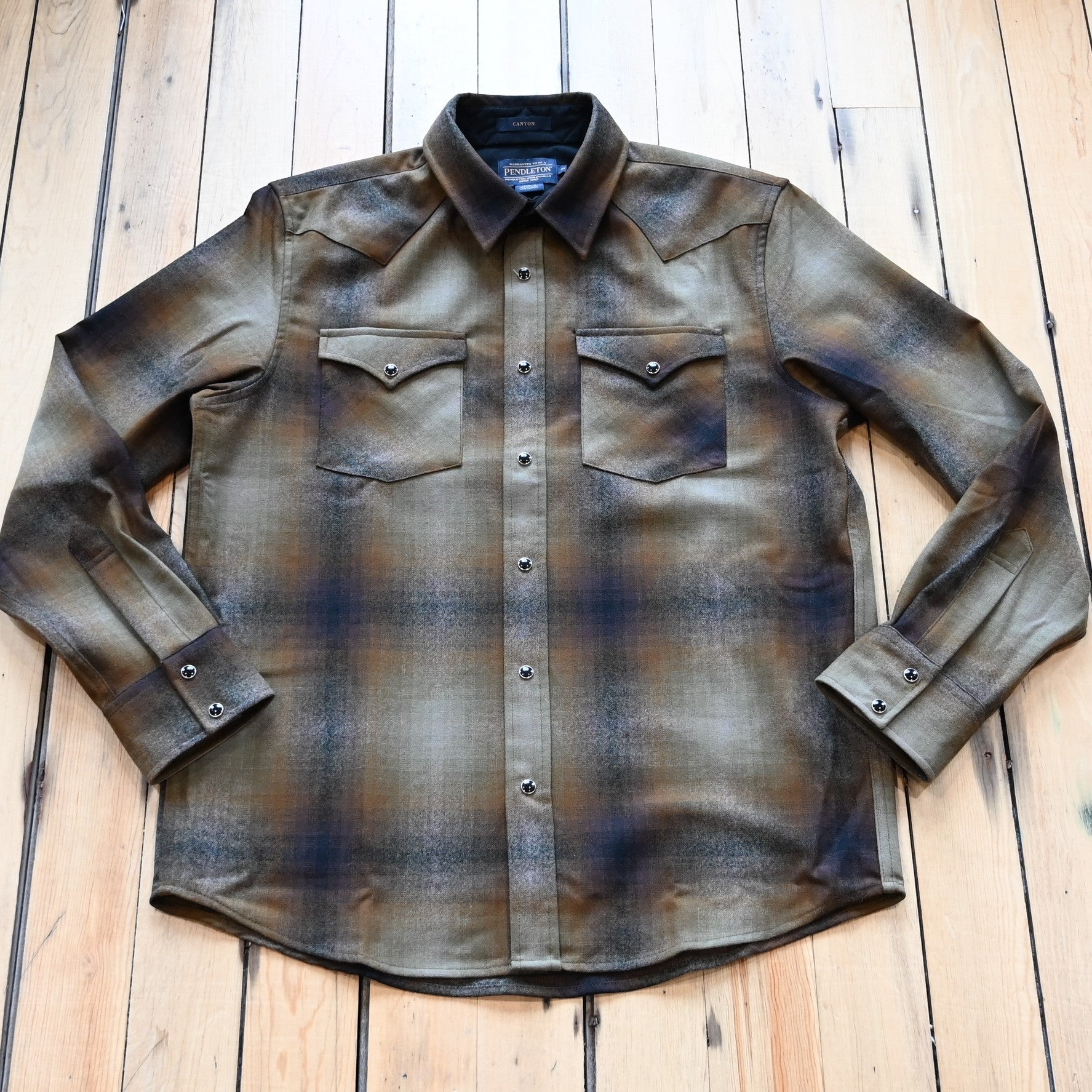 View of Pendleton men’s Canyon shirt in olive and brown ombré wool with snap front and Western yokes