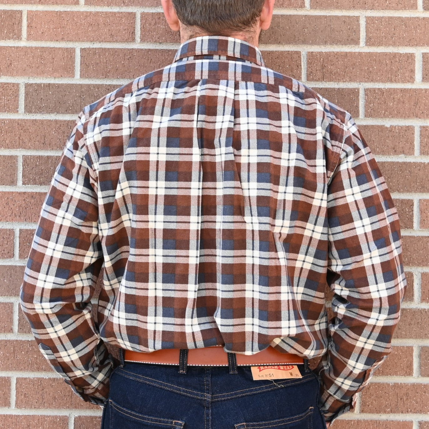View of Filson Field Flannel Shirt featuring button-close chest pockets and adjustable cuffs