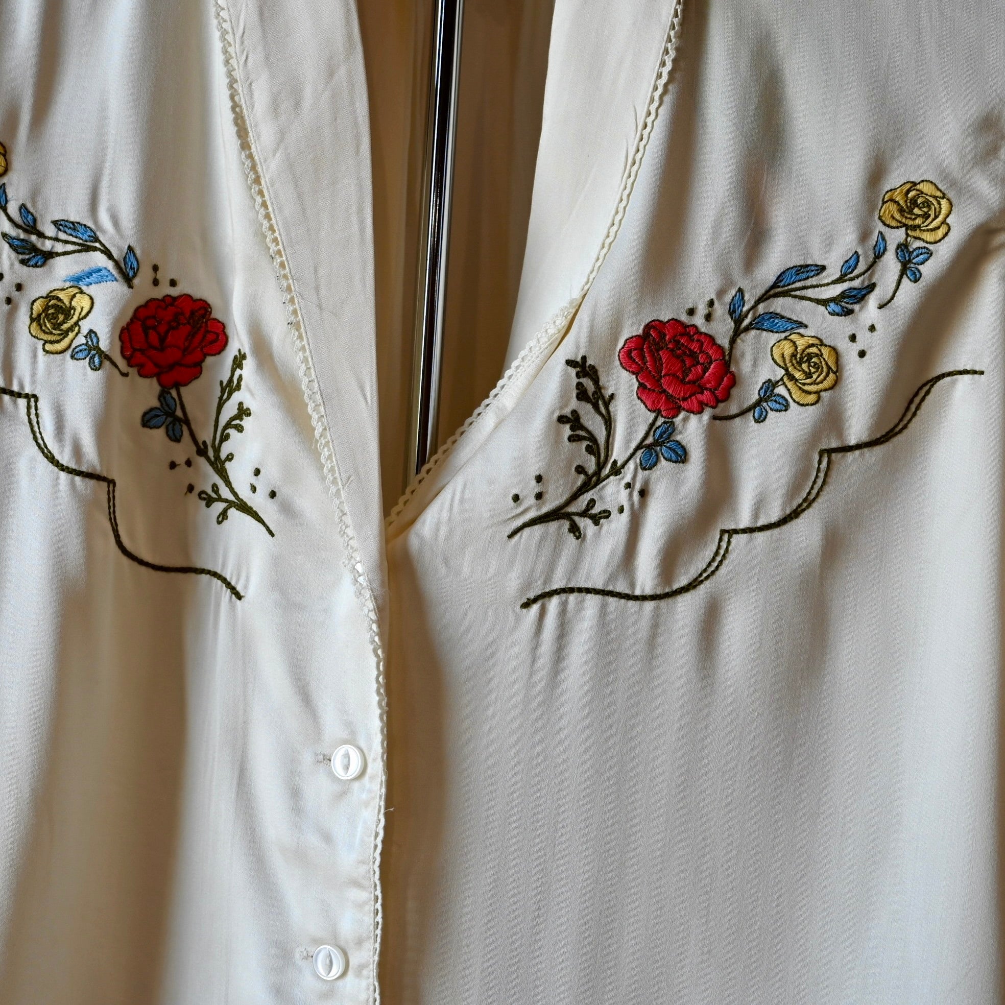 Silky white lace blouse by Sendero with floral embroidery and delicate cotton lace at collar and center front