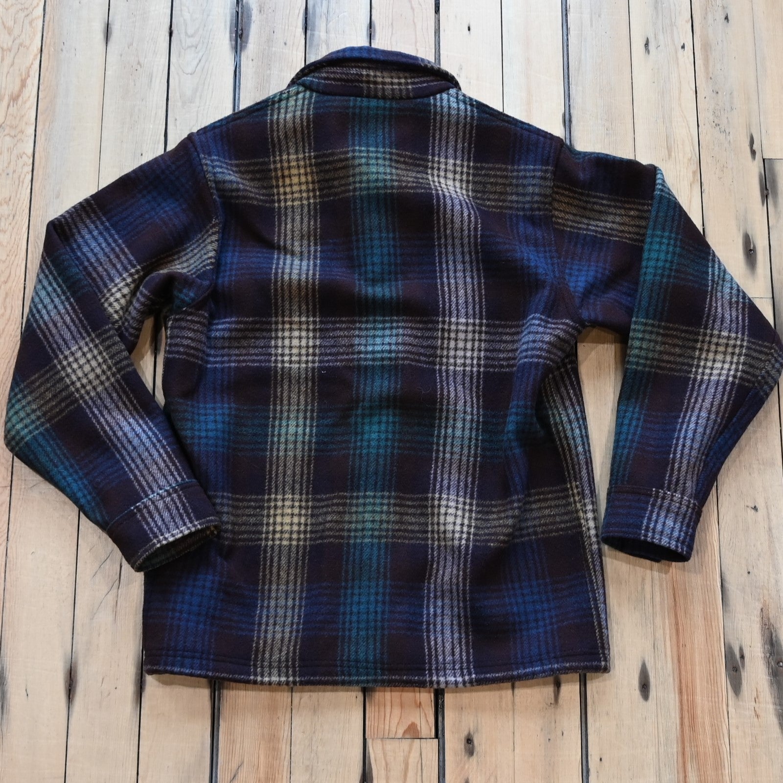 View of Filson Mackinaw Wool Jac-Shirt in Black Coffee Multi Plaid and Red/Black Ombre Plaid featuring button-front closure, adjustable cuffs, and hidden button-secured pockets