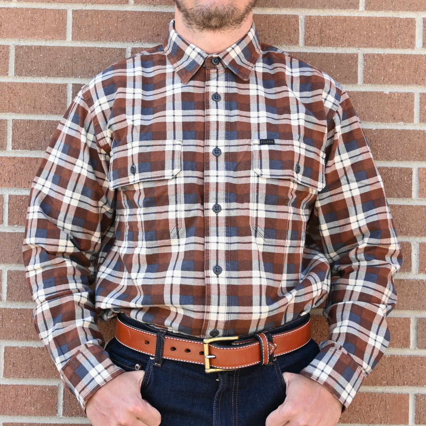 View of Filson Field Flannel Shirt featuring button-close chest pockets and adjustable cuffs