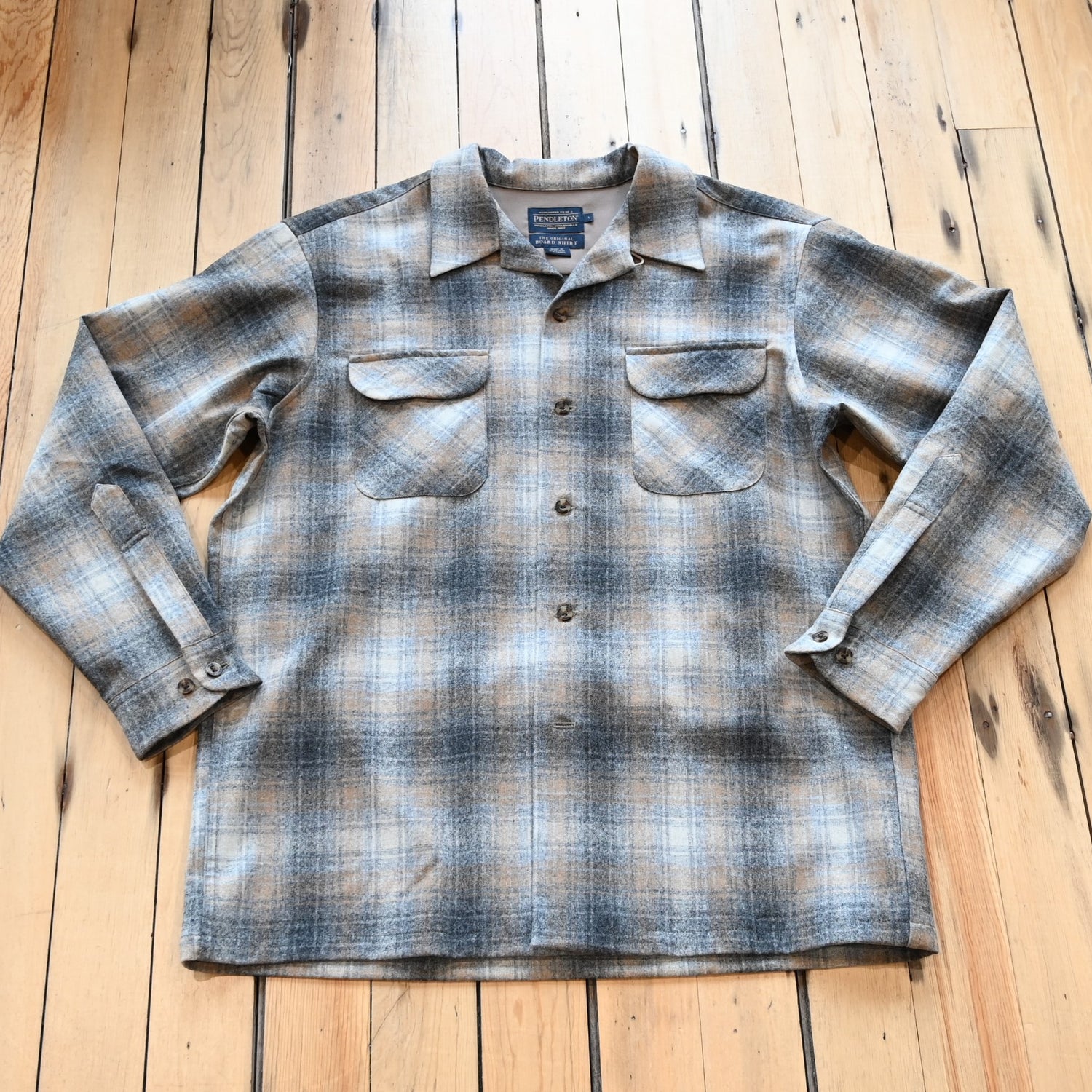 View of Pendleton men’s wool board shirt in grey and tan mix plaid with square hem and bias chest pockets