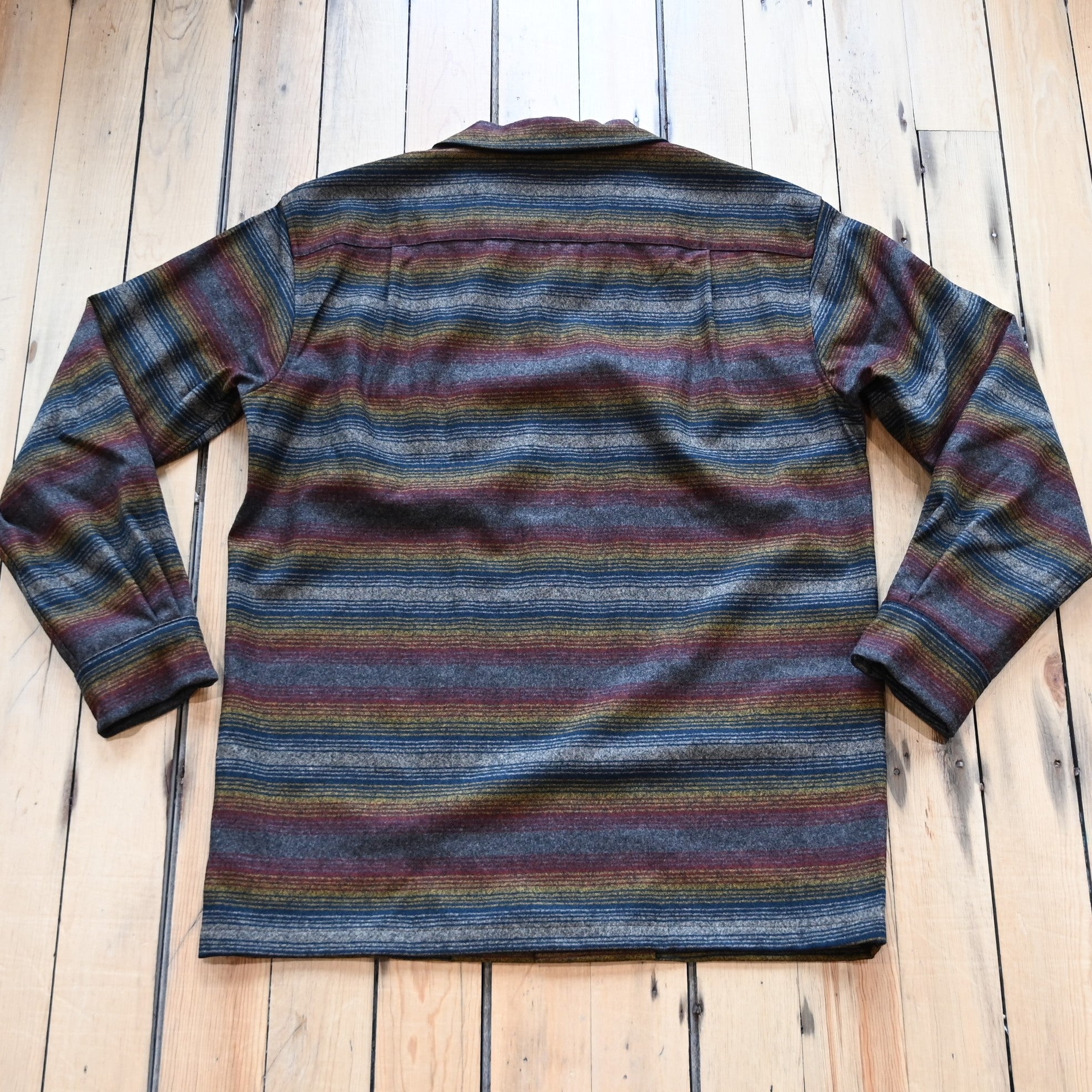 View of Pendleton men’s wool board shirt in brown multi ombré stripe with bias pockets and square hem