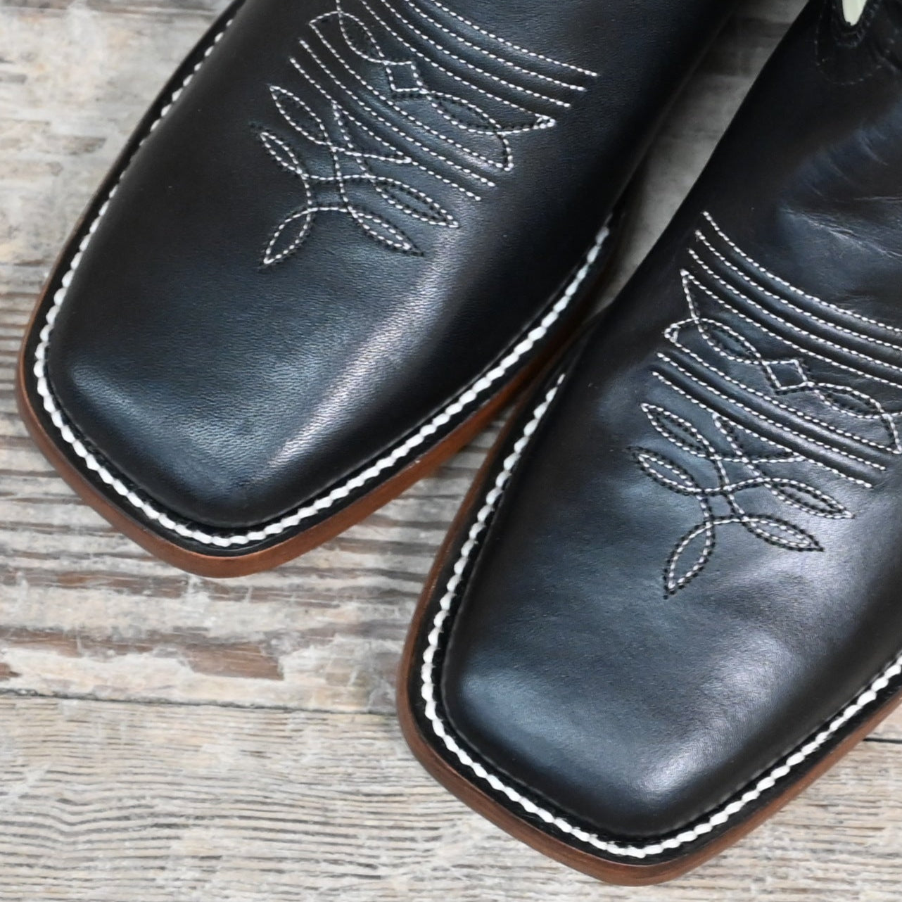 View of Hondo 11" cowboy boot with bone leather top, black steer vamp, and wide square toe