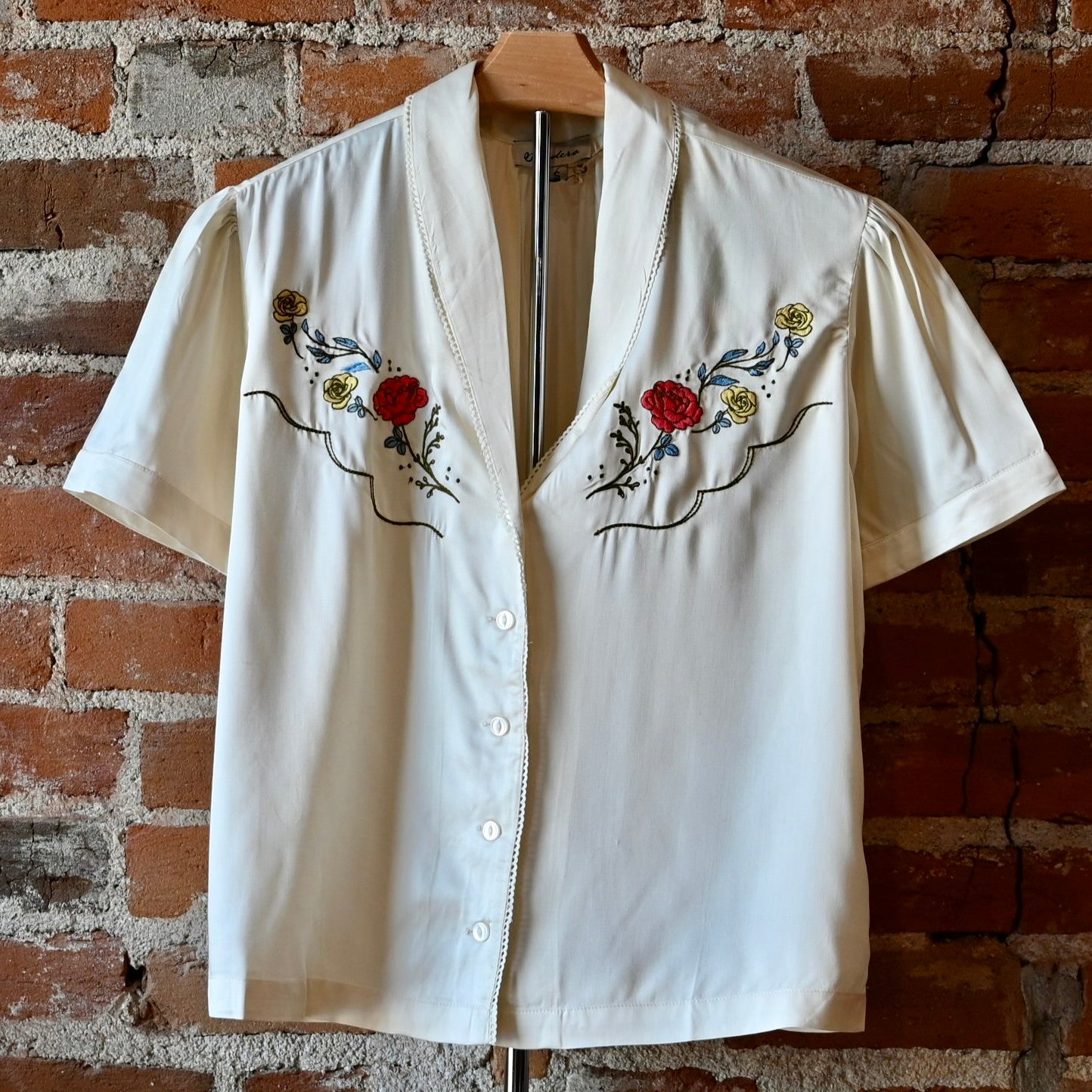 Silky white lace blouse by Sendero with floral embroidery and delicate cotton lace at collar and center front