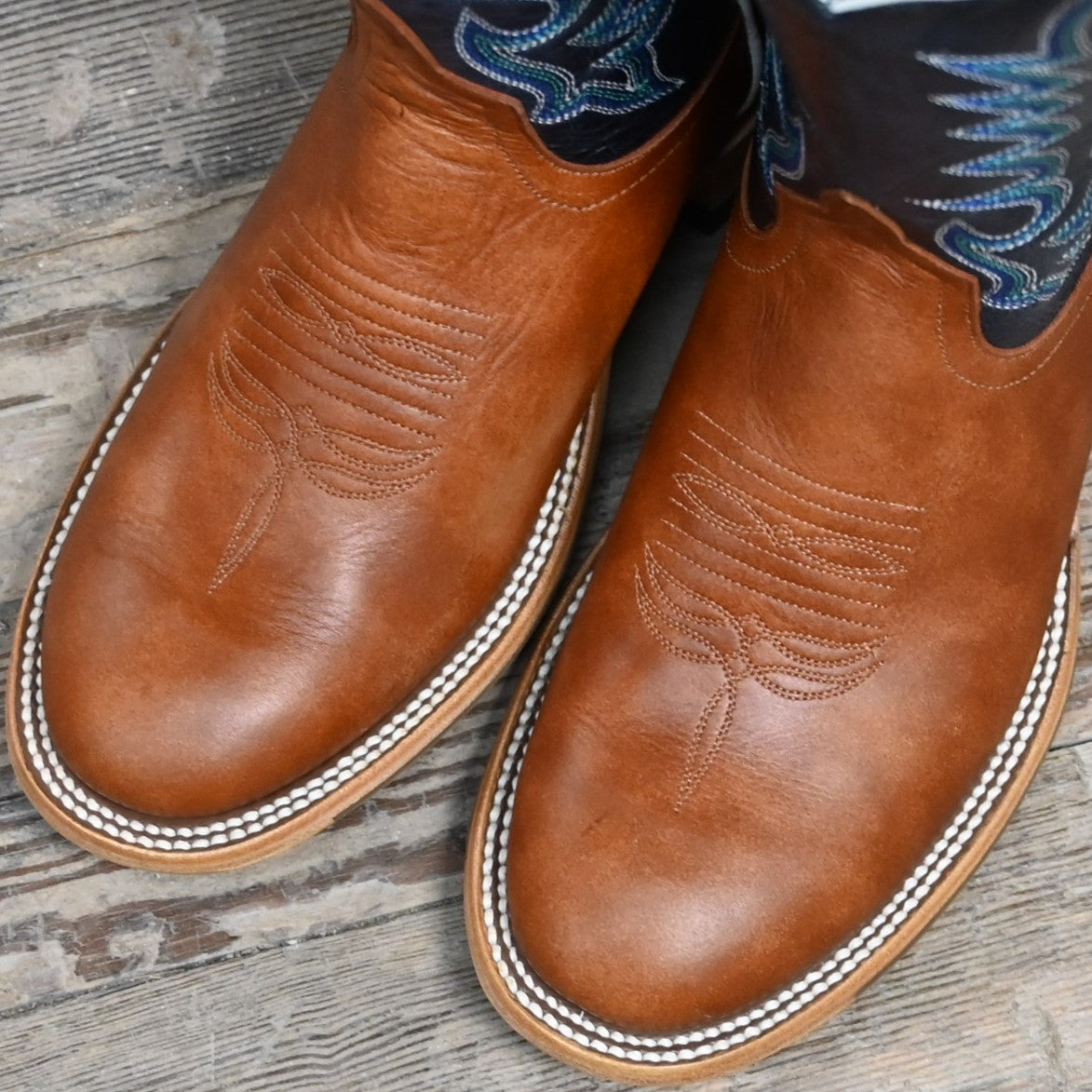 View of Horse Power 11" boot with navy goat top, cognac Belton vamp, medium round toe, and pull straps