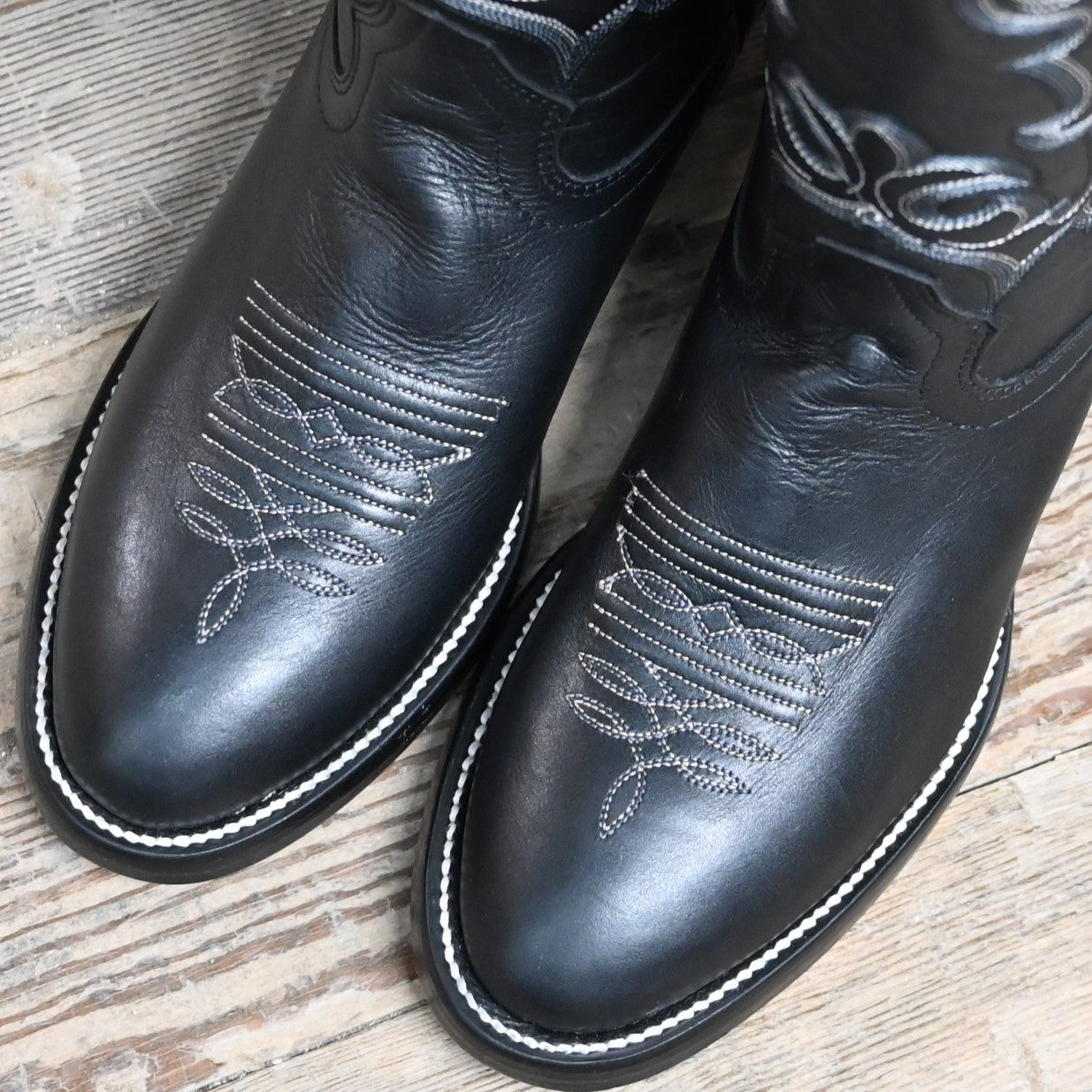 View of Hondo 16" cowboy boot with black retan vamp, natural lined top, flourished stitching, and spur ledge
