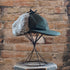 View of Filson Double Mackinaw Cap in Forest Green/Acorn and Burgundy/Dark Olive Plaid featuring shearling-lined earflaps and a 3" bill