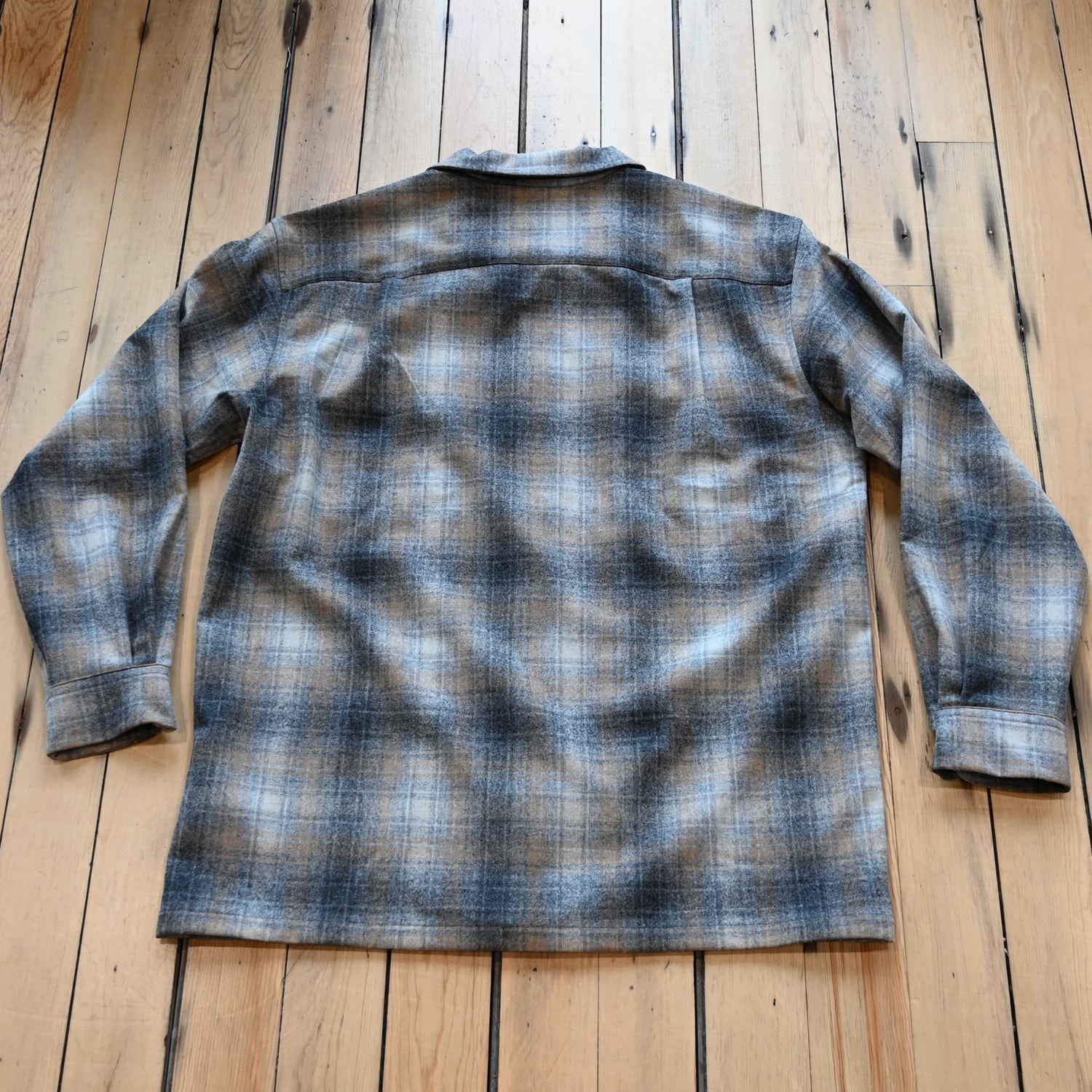 View of Pendleton men’s wool board shirt in grey and tan mix plaid with square hem and bias chest pockets