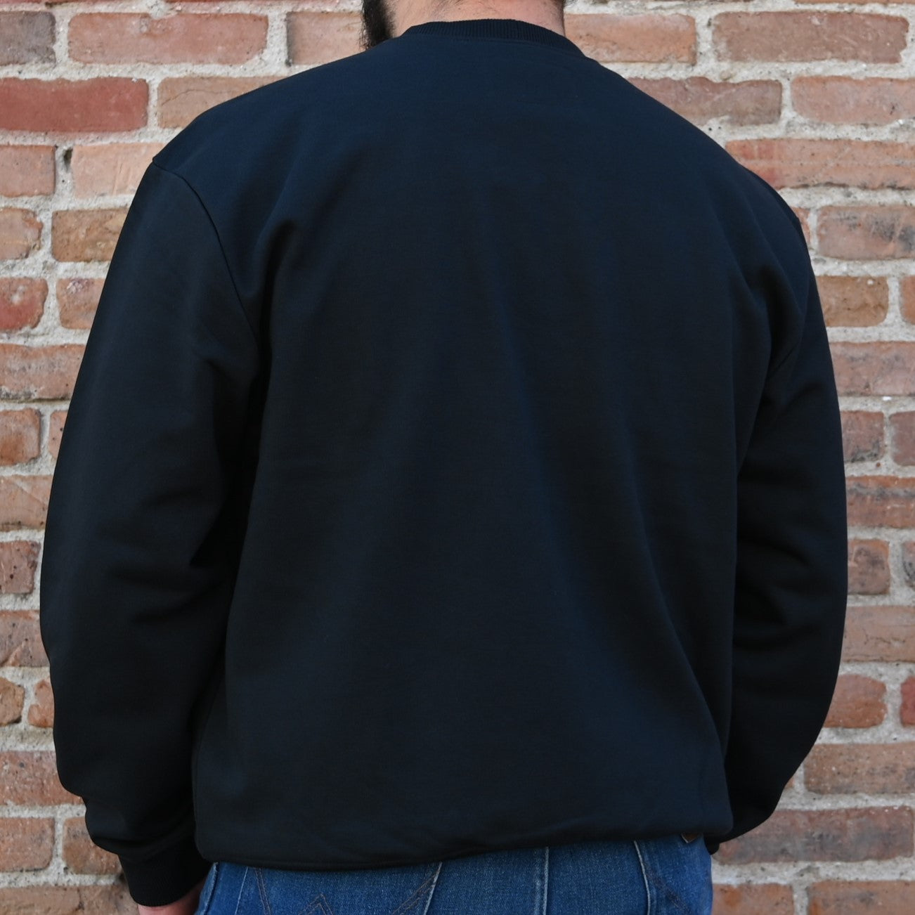 View of Filson Prospector Crewneck Sweatshirt in Black, showcasing the lofted fleece interior and rib-knit hem and cuffs